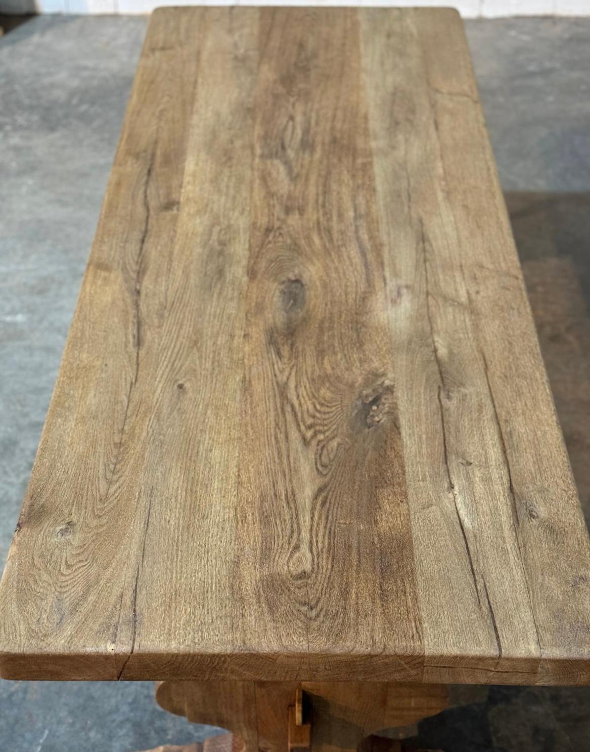 A lovely French Solid Oak Farmhouse Dining Table with hearts in the trestle supports, a nice feature. Lovely characterful thick top. Dating to the early 1900s and of excellent quality construction. We have bleached it for a lighter look and it