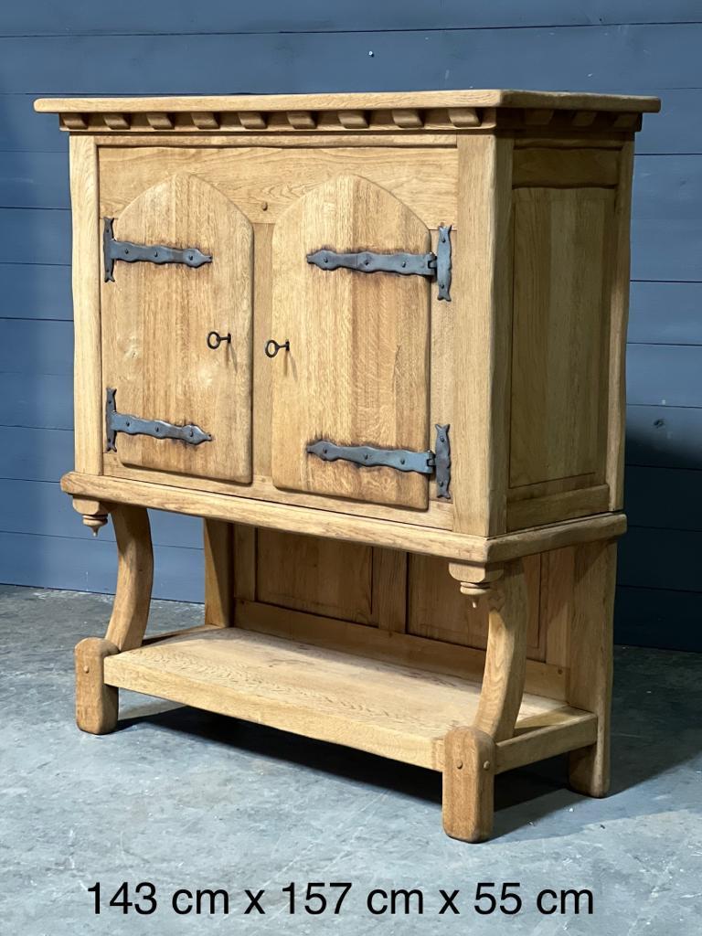 A lovely Stylish Gothic Oak 2 door cupboard. French in origin and made from solid Oak which we have bleached. The doors are lockable (keys present) and open to reveal a single shelf inside. Hand forged iron hinges and panelled back this piece is