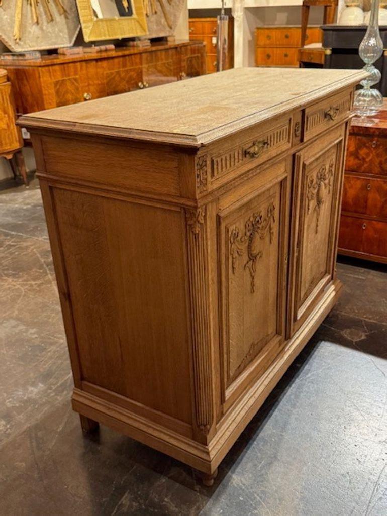 19th century French carved and bleached white oak side cabinet. These cabinets are perfect for layering texture into a neutral interior or adding character to a hallway or dining room. Bleached white oak side cabinets are timeless accents that bring