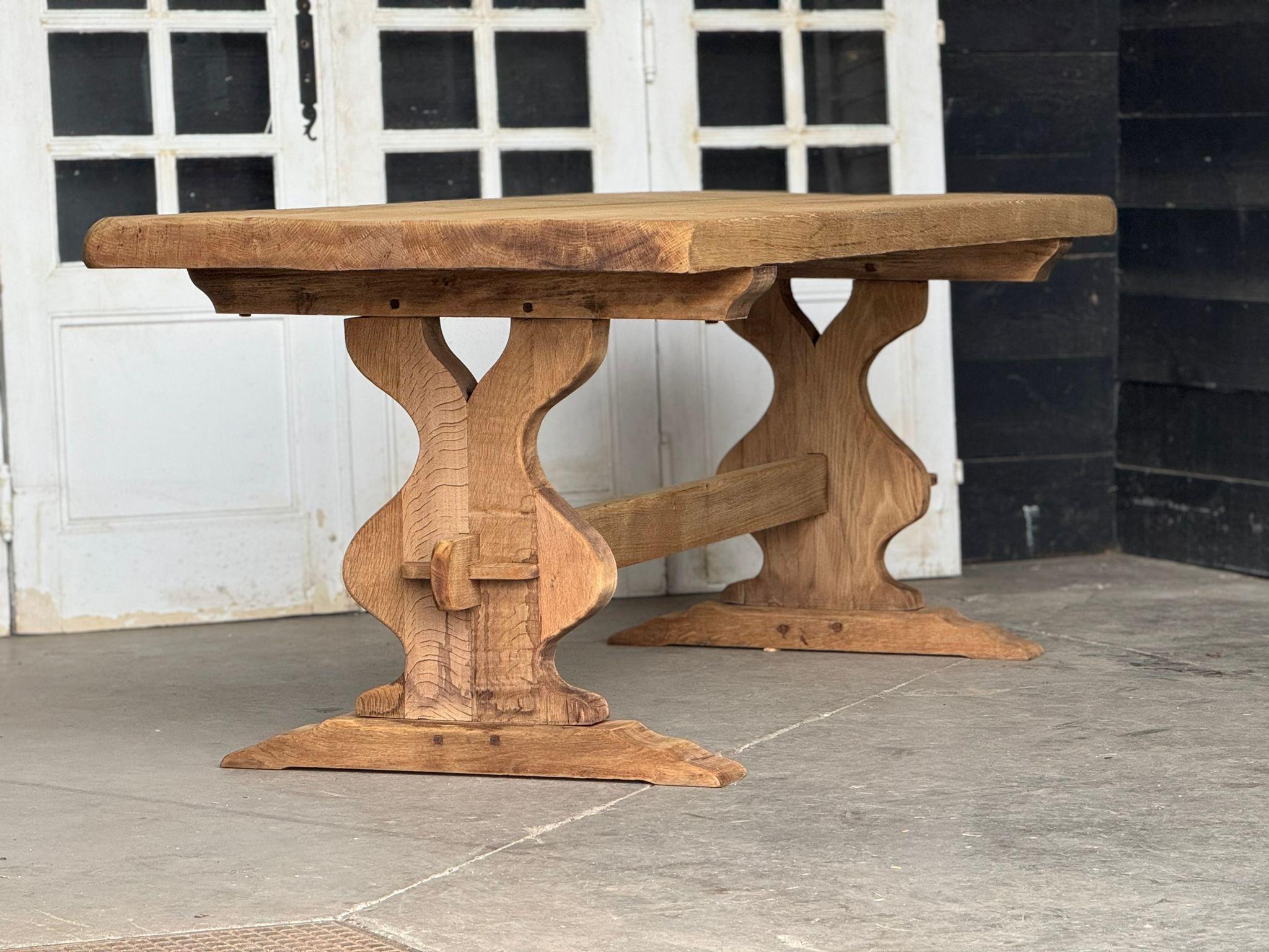 A good Quality solid Oak Farmhouse Dining Table. French in origin and dating to the early 1900s. It completely comes apart for easy access into the home. We have bleached it for a lighter look and to bring out the natural beauty of the wood. In