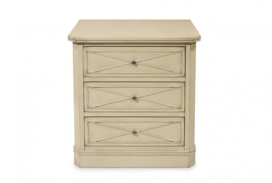 Blow is a bedside table with 3 drawers, shown in cherry wood with a light grey finish. It features exquisite hand-carved detailing to the front of the drawers and delicate knobs in antique brass.

· Handcrafted in cherry wood, oak, mahogany or