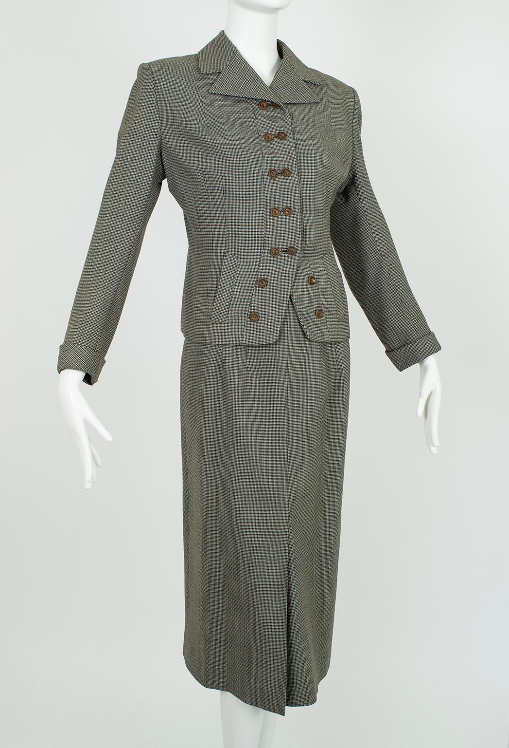 A wartime Girl Friday suit with style to spare despite its adherence to clothing rations. The punchy double-button jacket detail is emblematic of the creative use of everyday materials at a time when flashy dressing was considered unpatriotic.