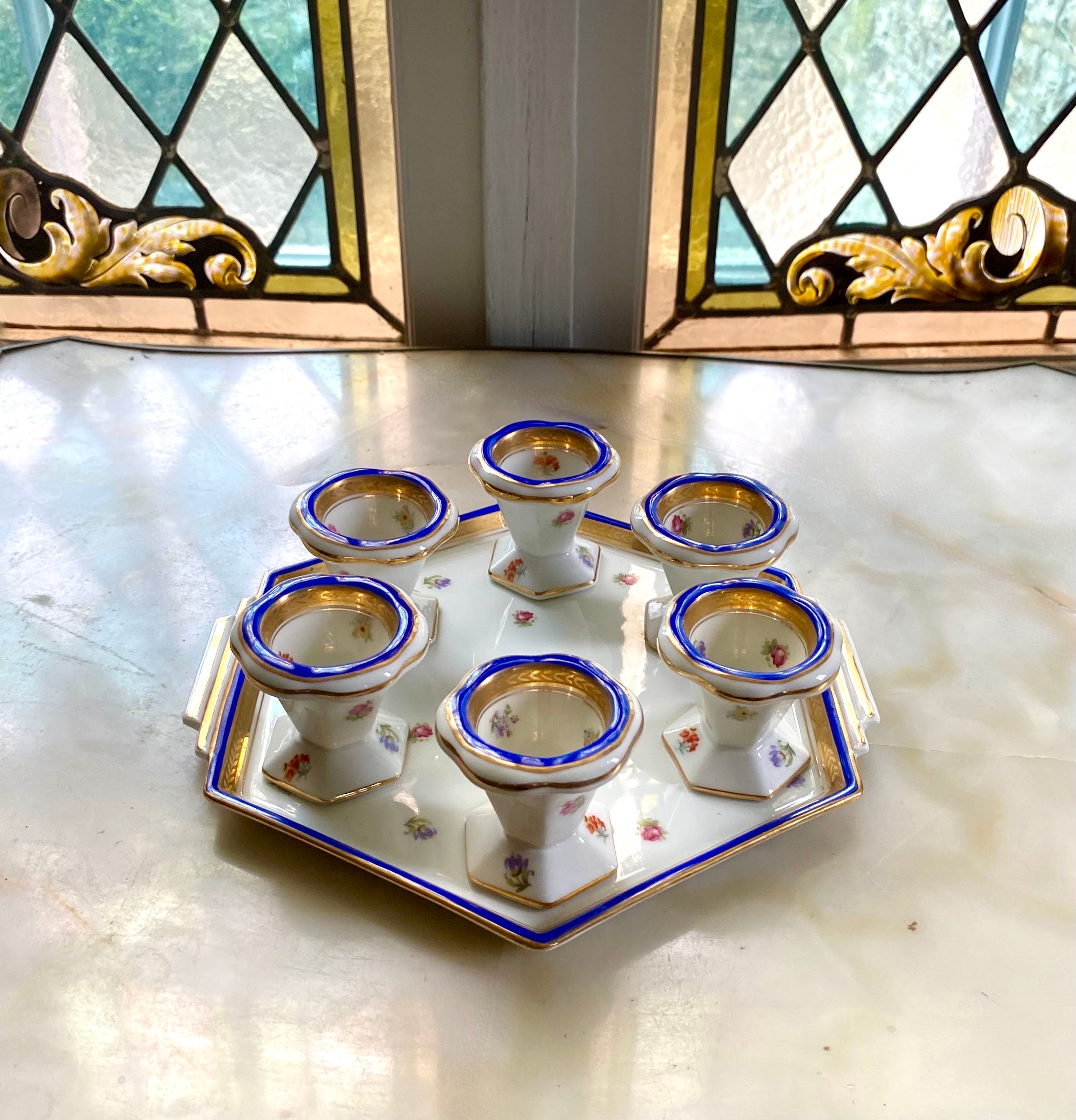 Pretty soft-boiled egg service including 6 egg cups and a matching Limoges porcelain tray.
Decorated with small pink, orange and purple flowers.
Striking colors of French Blue as well as several gold edgings on the outside and inside of the egg