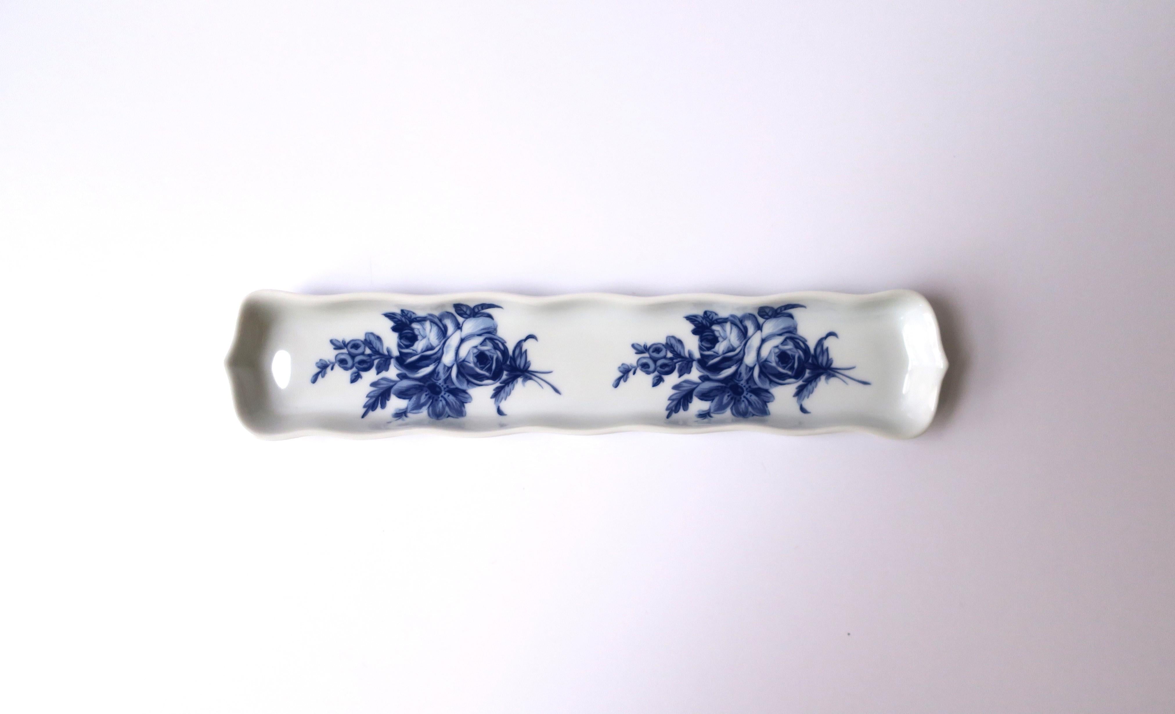 A French blue and white porcelain jewelry dish with a floral 'chintz' design, in the Rocco style, circa late-20th century, France. Made in France. A beautiful oblong piece with decorative edge and blue flowers. Great for holding jewelry on a