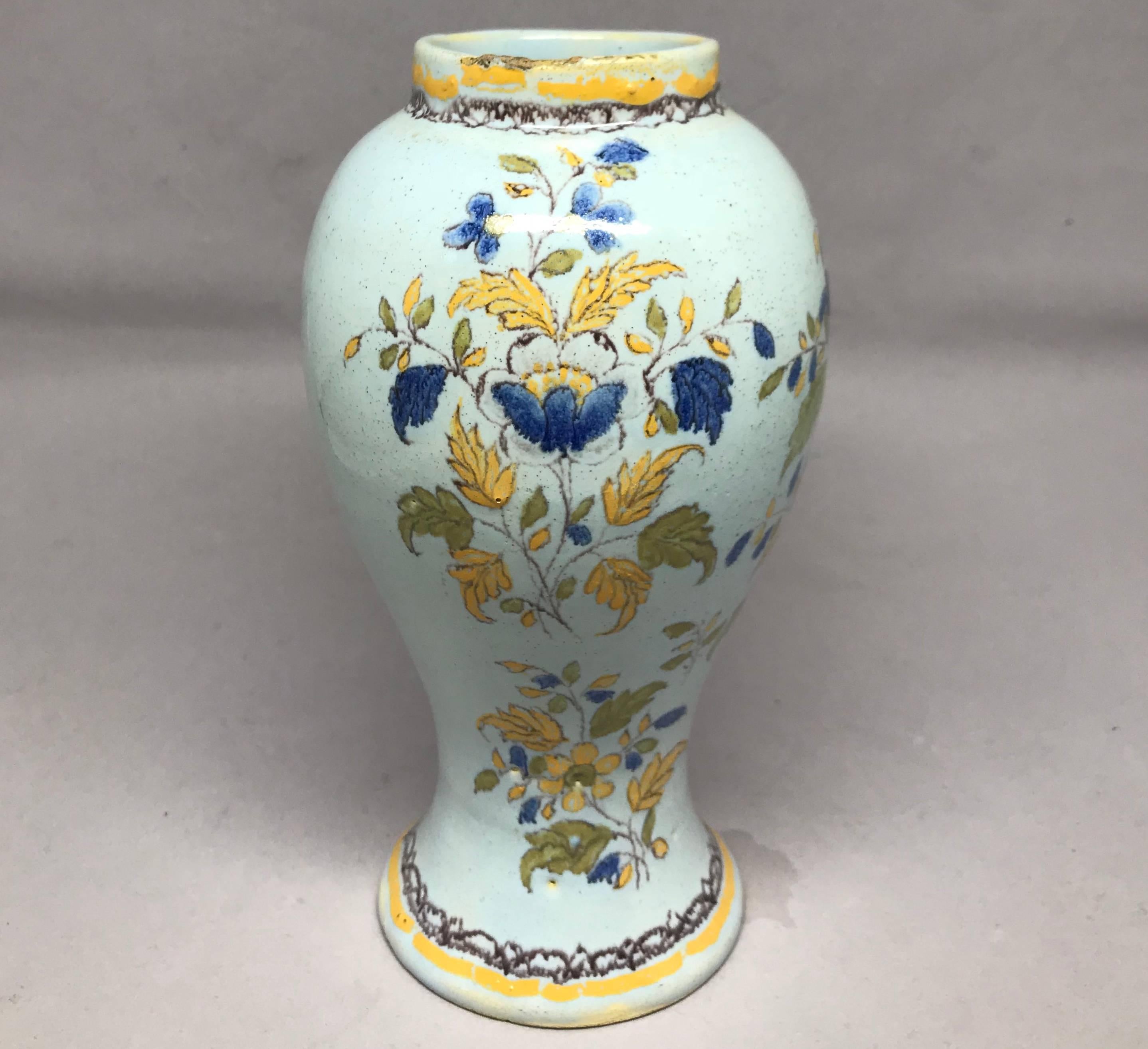 French blue and yellow faience vase. Moustiers vase in pale blue tin glaze with blue and yellow flowers, France, 19th century.
Dimensions: 3