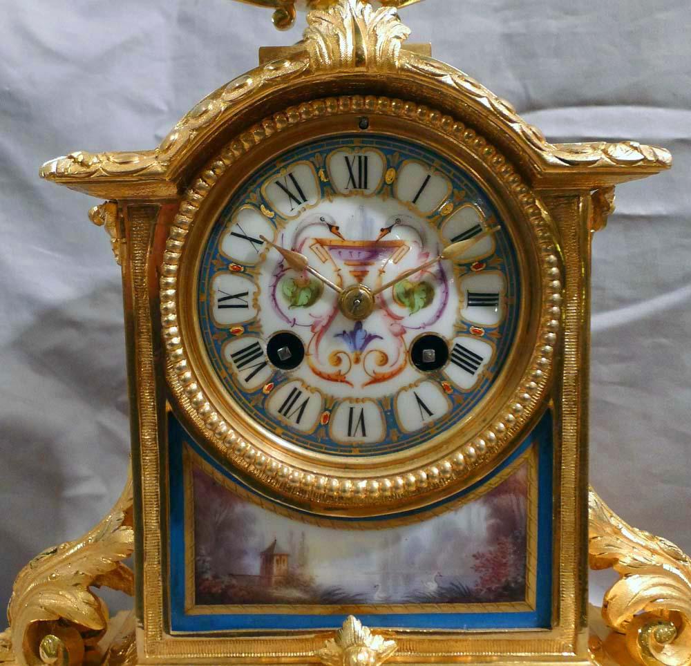 French blue celeste porcelain and ormolu mantel clock. Very good condition with original ormolu and no damage to the porcelain panels, some of which have neo-classical influence. Two birds heads are each side of the ormolu mounted blue celeste urn