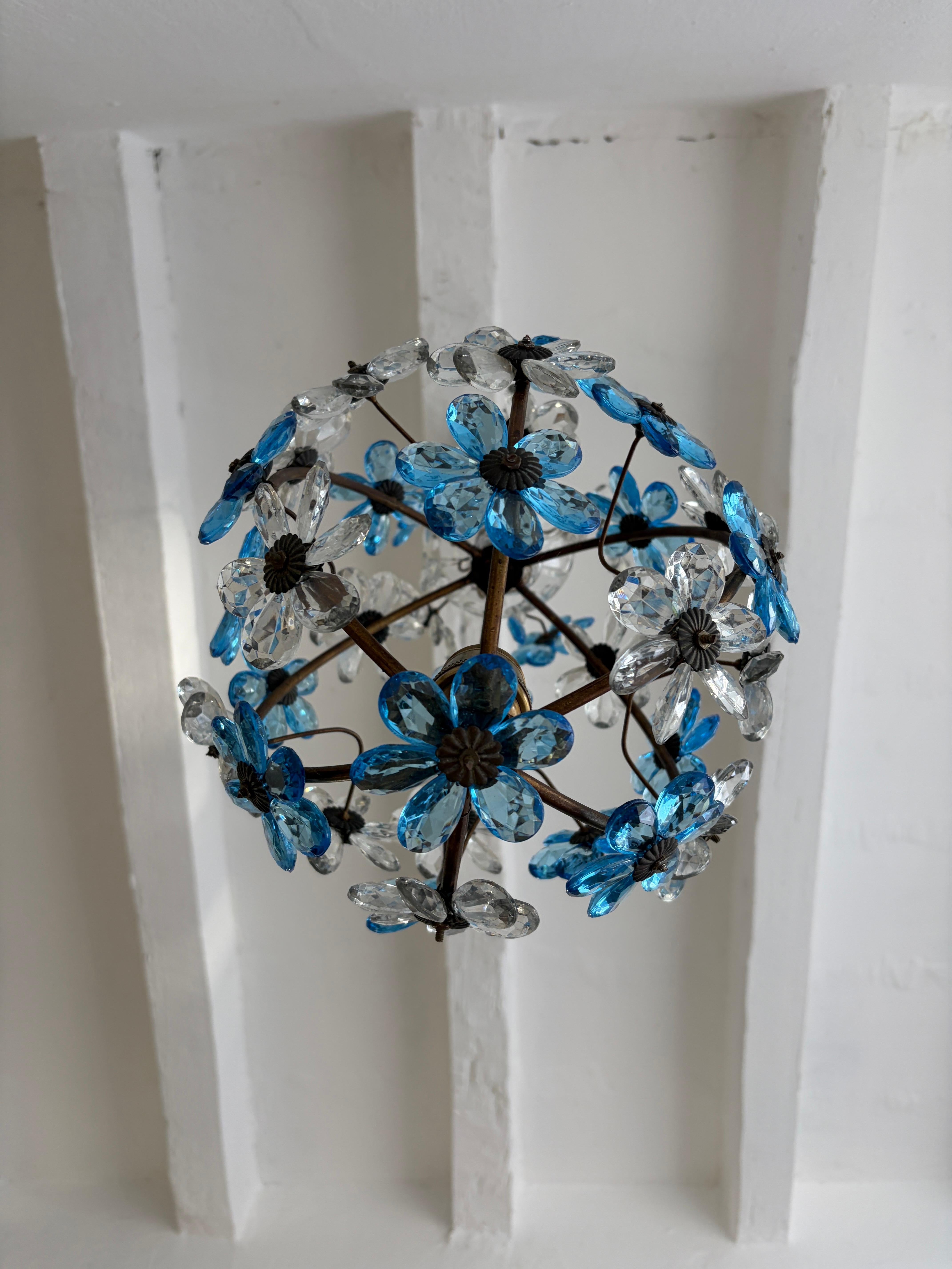 Housing 1 big light inside. Chandelier has been newly rewired with certified US UL socket for the USA and appropriate socket and ready to hang. Blue and clear crystal prisms, 6 petals each and 36 total flowers. Murano glass and crystal bobèche