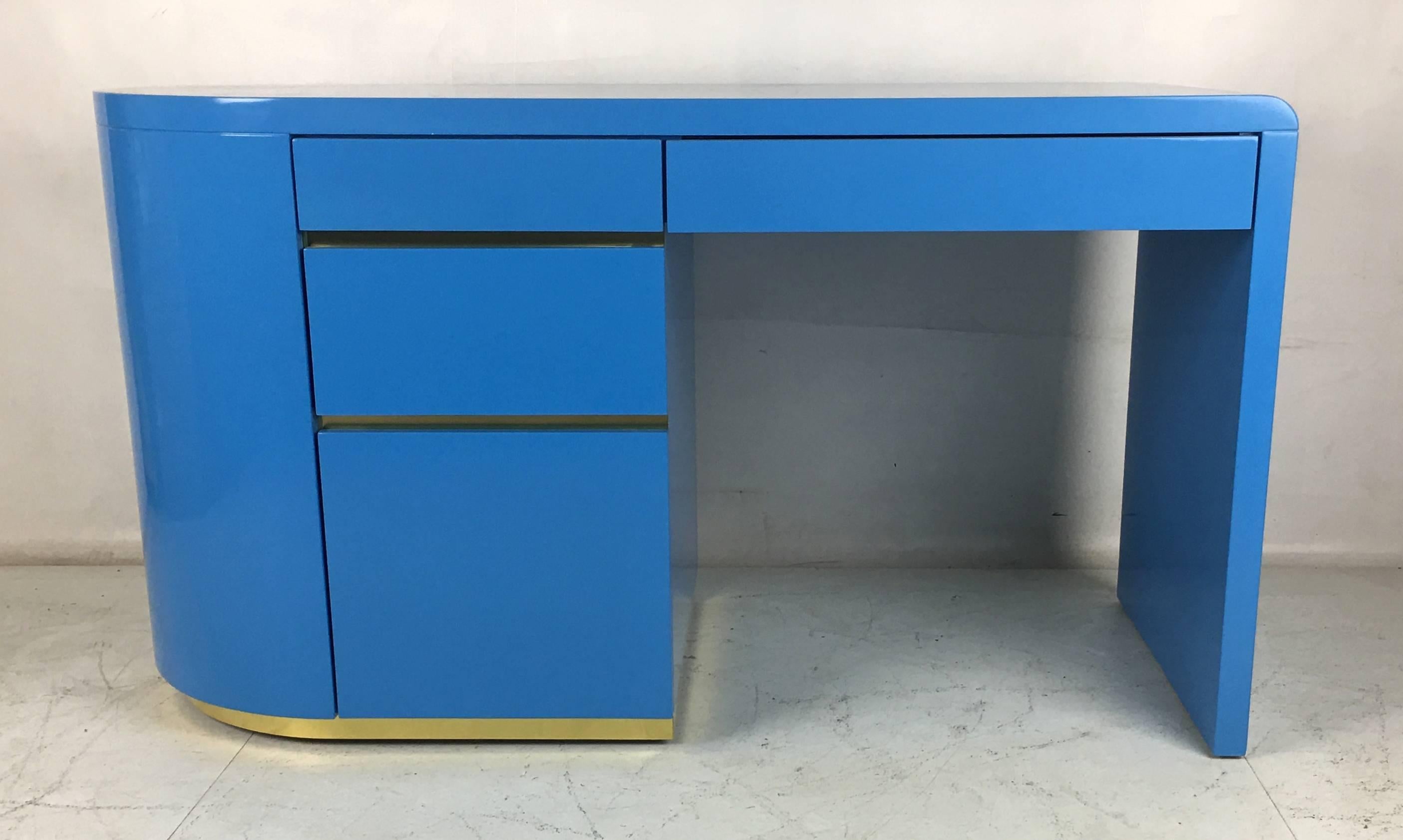 Luxurious writing desk refinished in hand polished Gauloise blue lacquer in the style of Steve Chase. The solid brass trim has been replaced with new material. 

Dimensions:
55 x 24 x 30.5
Kneehole- 25 high x 25.5 wide.