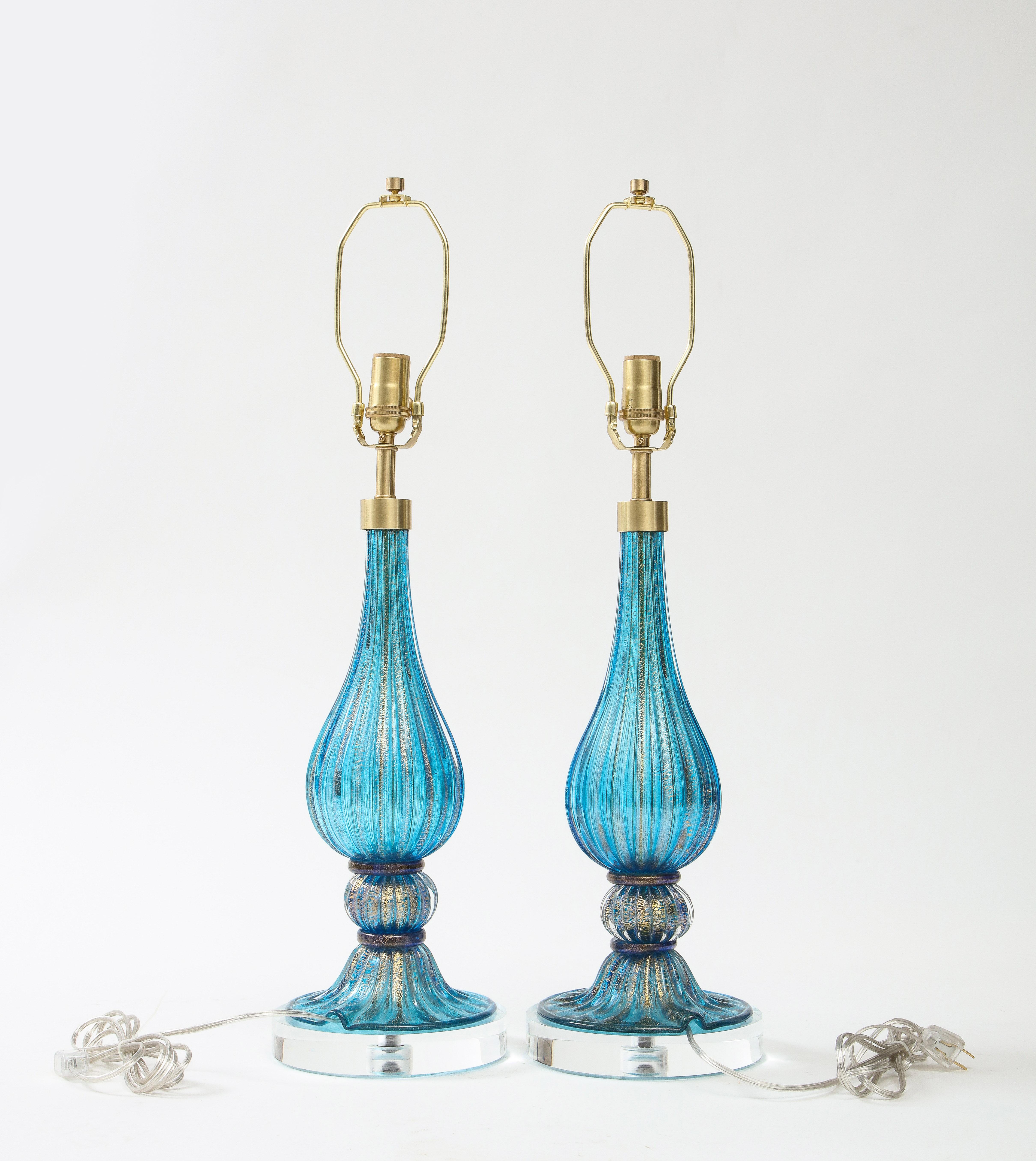 Barovier influenced Murano glass lamps with a Classic design of a fluted teardrop body, orb and saucer base. Hand blown glass is a beautiful vibrant French Blue with a scattering of 22kt gold inclusions. Lamps have been rewired to USA standards with