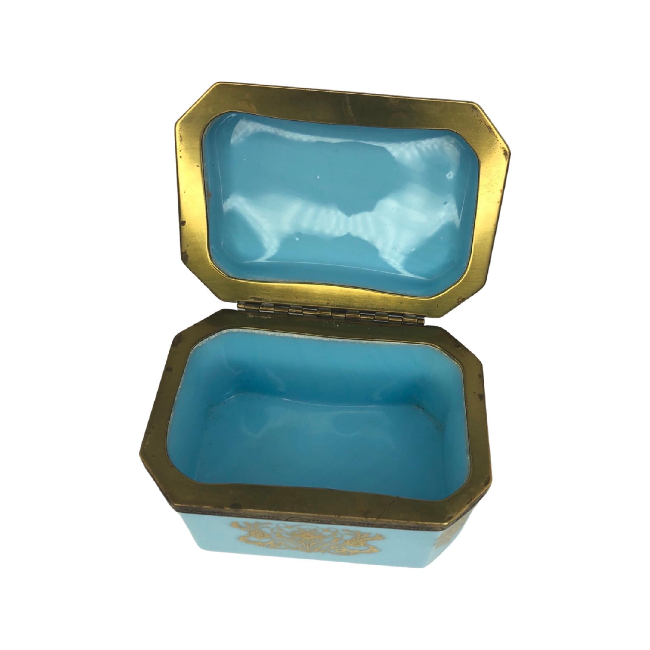 French blue opaline and bronze jewelry or vanity box, hand painted with delicate gold decoration. This early 20th Century French box is small yet heavy in weight for its size. The jewelry box has bronze fittings with applied gilt decoration. These