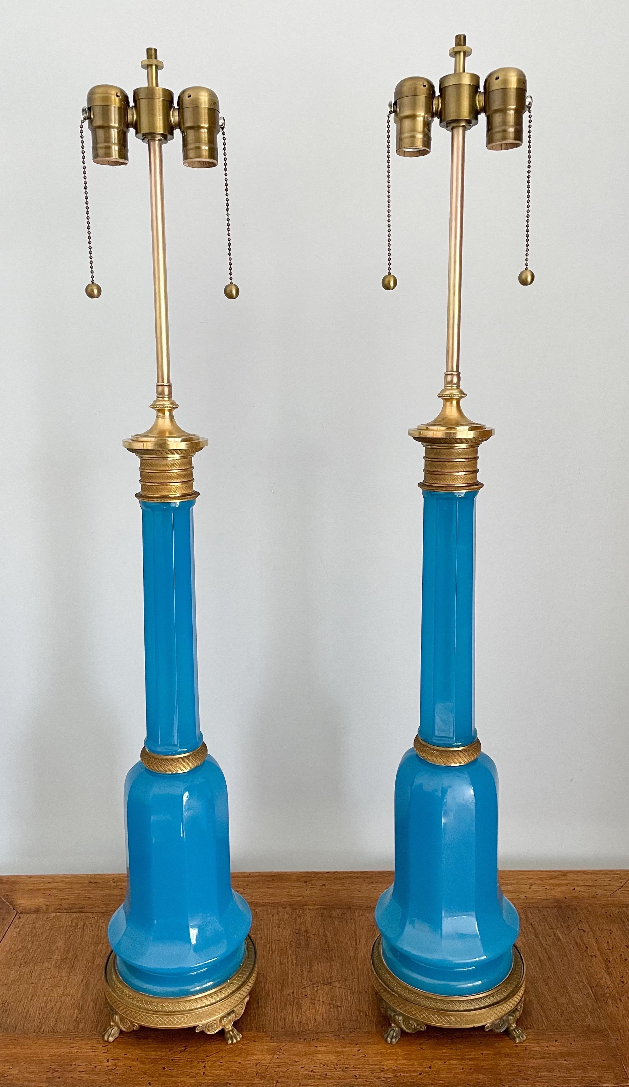 Wonderful, pair of antique French blue opaline lamps in the Neoclassical style.

Each lamp consists of an opaline glass body in a beautiful shade of blue and fine bronze ormolu decorations. 

The lamps are newly wired and require 2 Edison-base