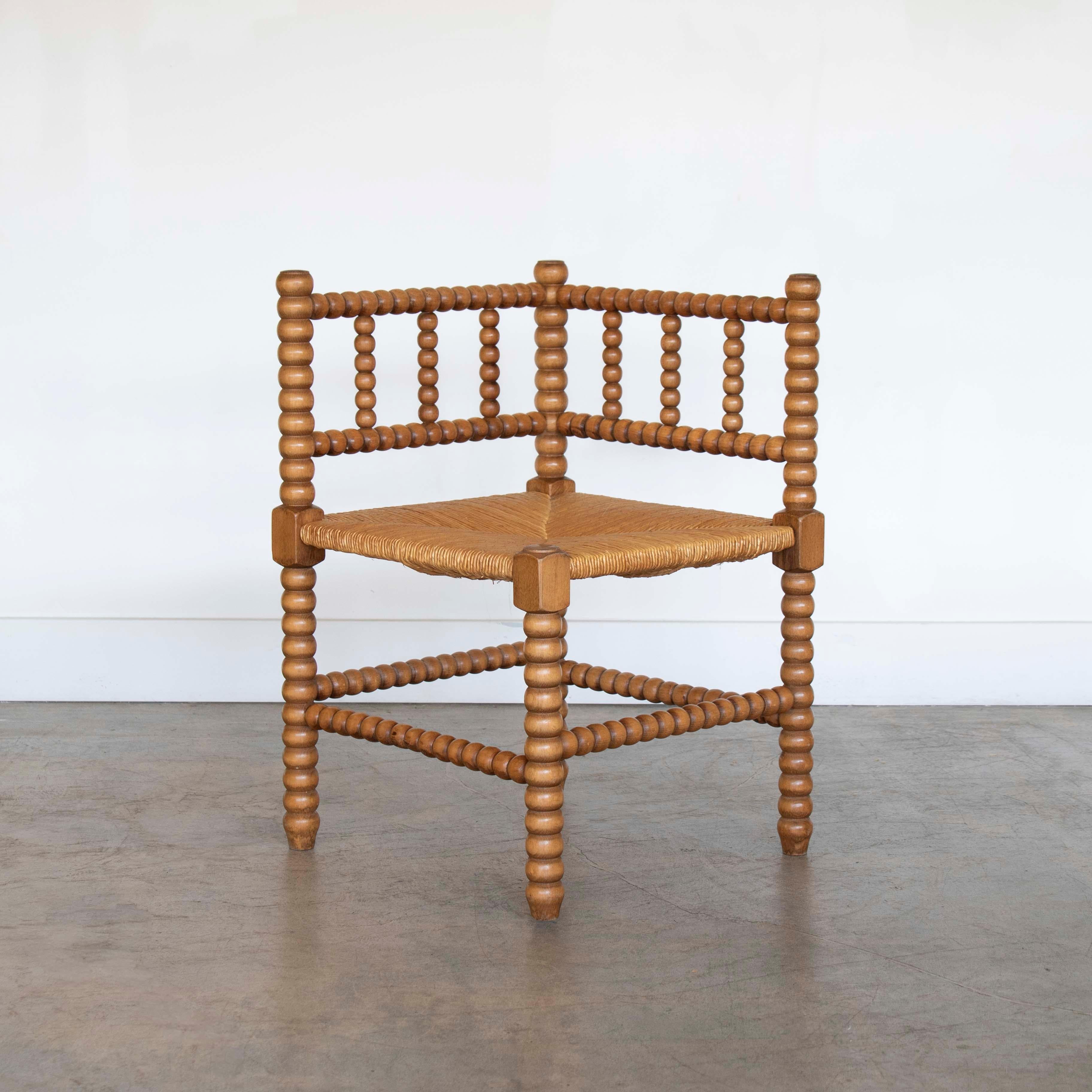 Vintage wood and woven corner chair from France, 1940's. Original wood bobbin frame with woven rush seat. Small scale with great patina and age. 