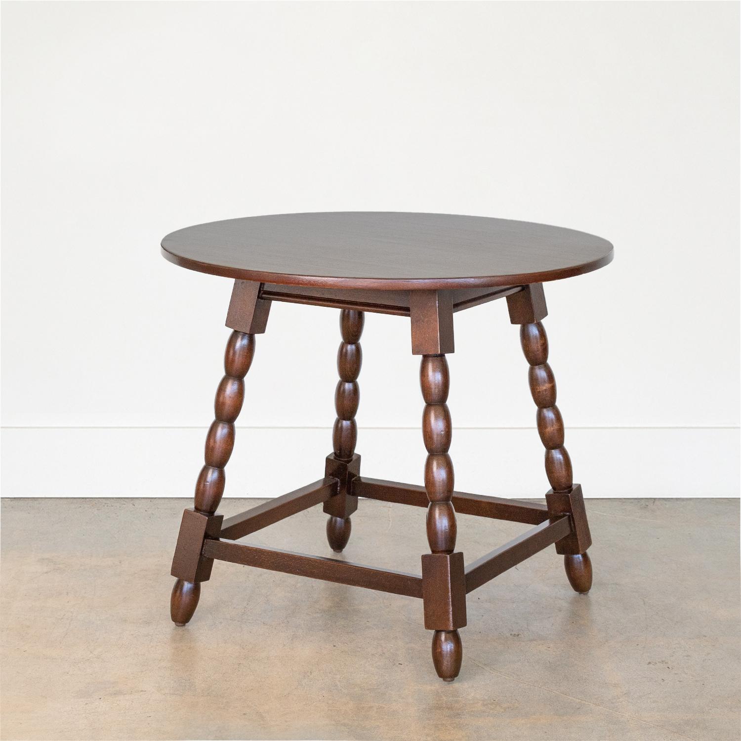 Large 1940s French wood circular table with four angled bobbin legs and large circular top. Newly refinished in a dark stain.