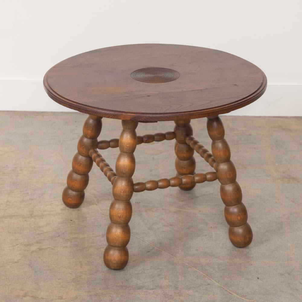 Beautiful carved wood side table by Charles Dudouyt from France, 1940s. Circular top has beautiful carved ring detail and four carved bobbin legs. Original wood finish with nice age markings and patina. Perfect between two chairs.