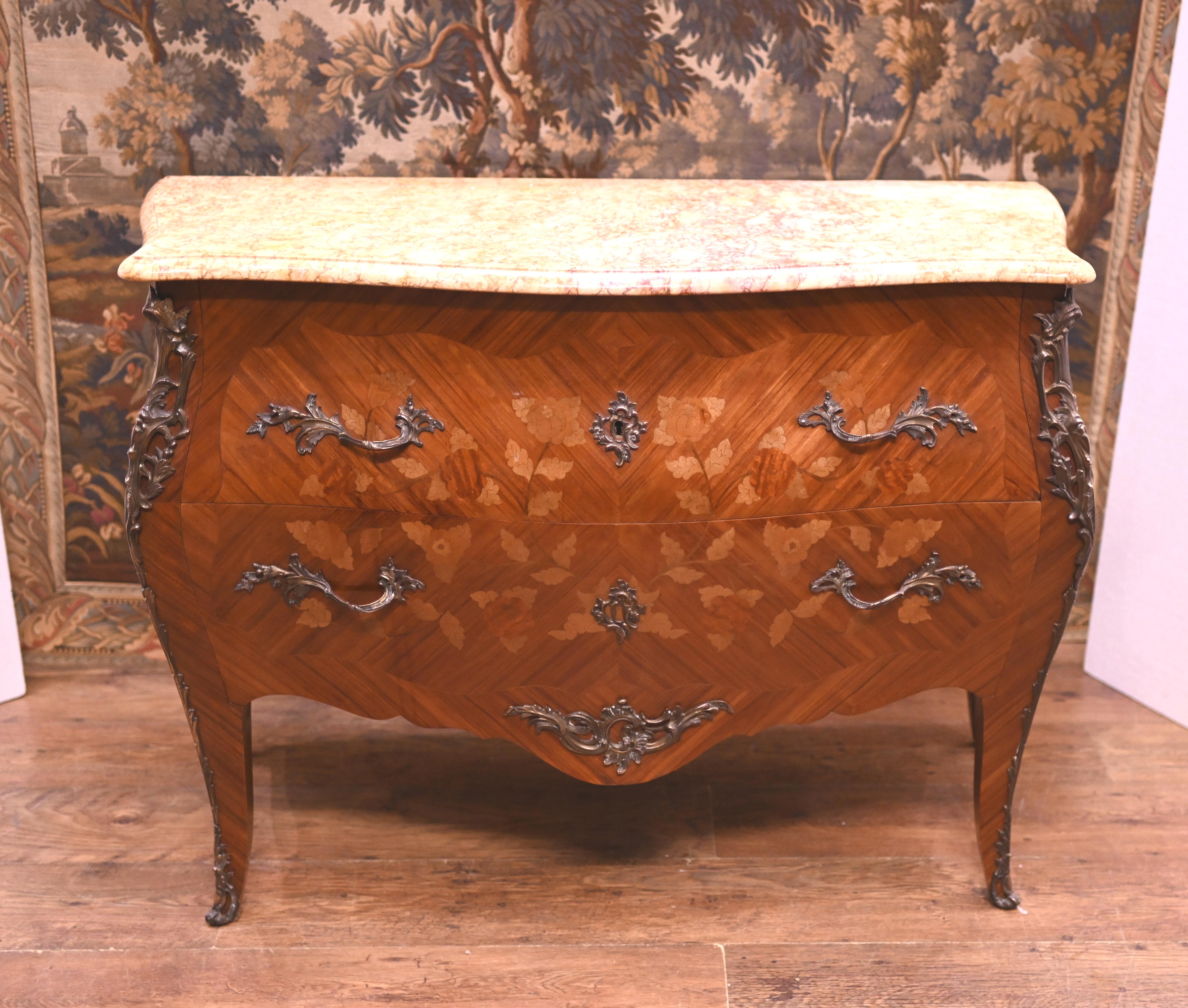 Refined French Empire commode - or chest of drawers - of bombe form
Two large drawers which feature intricate marquetry inlay to the front
Ormolu mounts are original and well cast
Marble top is smooth and chip free and the kingwood has a lovely