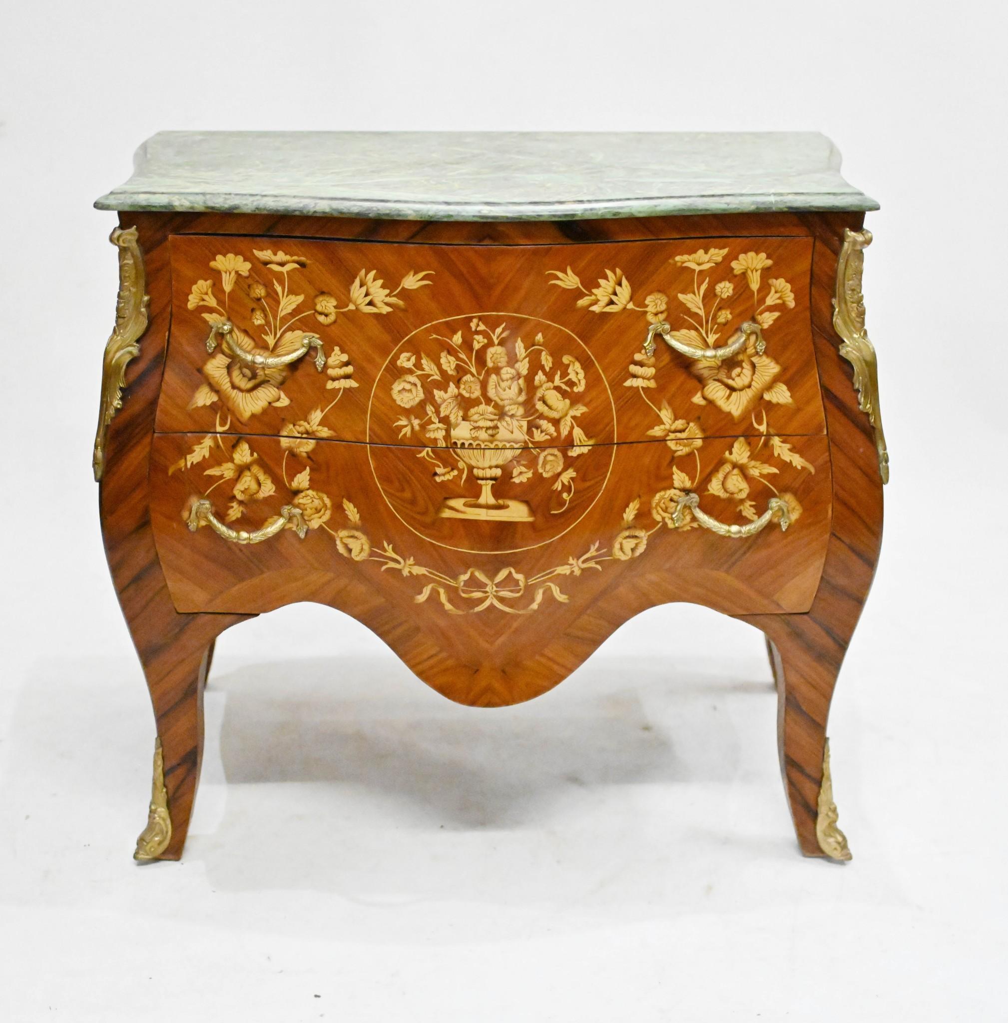 Gorgeous French bombe commode in the Empire manner
Bombe refers to the exaggerated shape of the chest
Intricate marquetry inlay work is proffuse and very technical A marquetry french commode with a marble top
Bought from a dealer on Marche Biron at