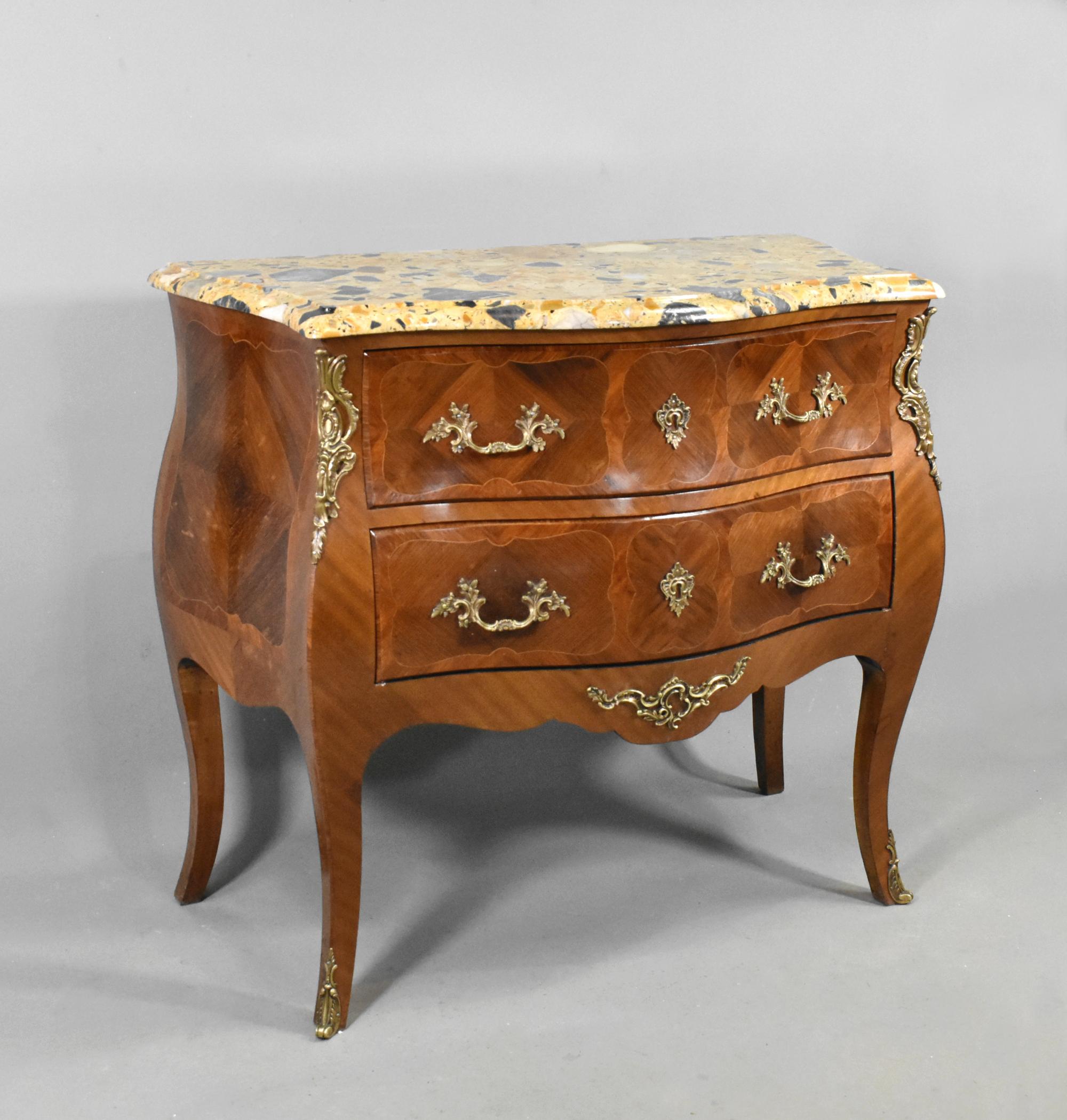 French Bombe Commode Louis XV Style 

This attractive French Bombe Commode features a stunning free-standing Breche marble top with a moulded outer edge. This is removable for transport.

The commode has two full-width drawers which are decorated