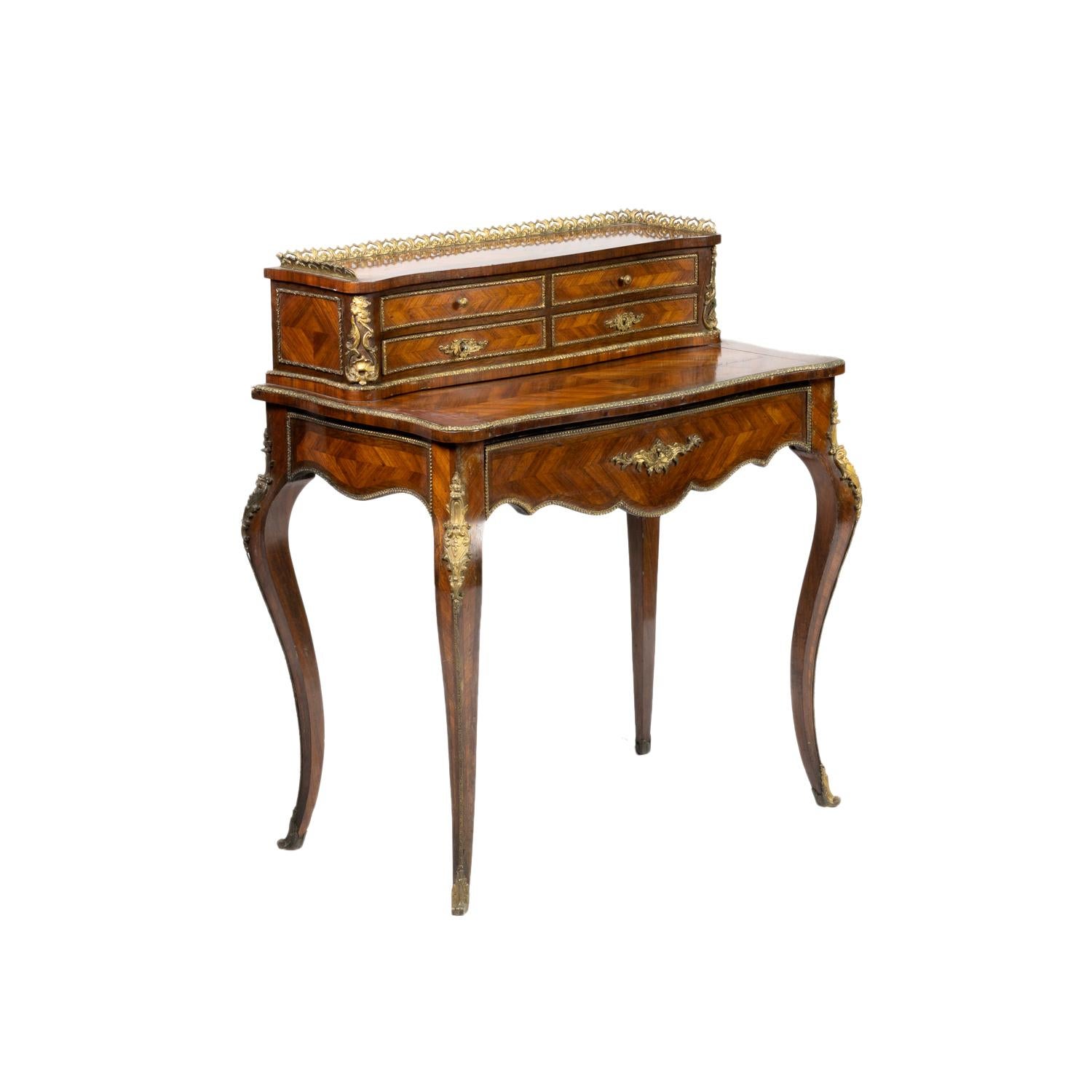 A rare Bonheur Du Jour with gilt brass mounts and exquisite marquetry inlay with French Sèvres Style Porcelain and Ormolu Mounted.
A Louis XVI Style 19th Century piece with four upper draws and one large lower draw with golden rails raised on