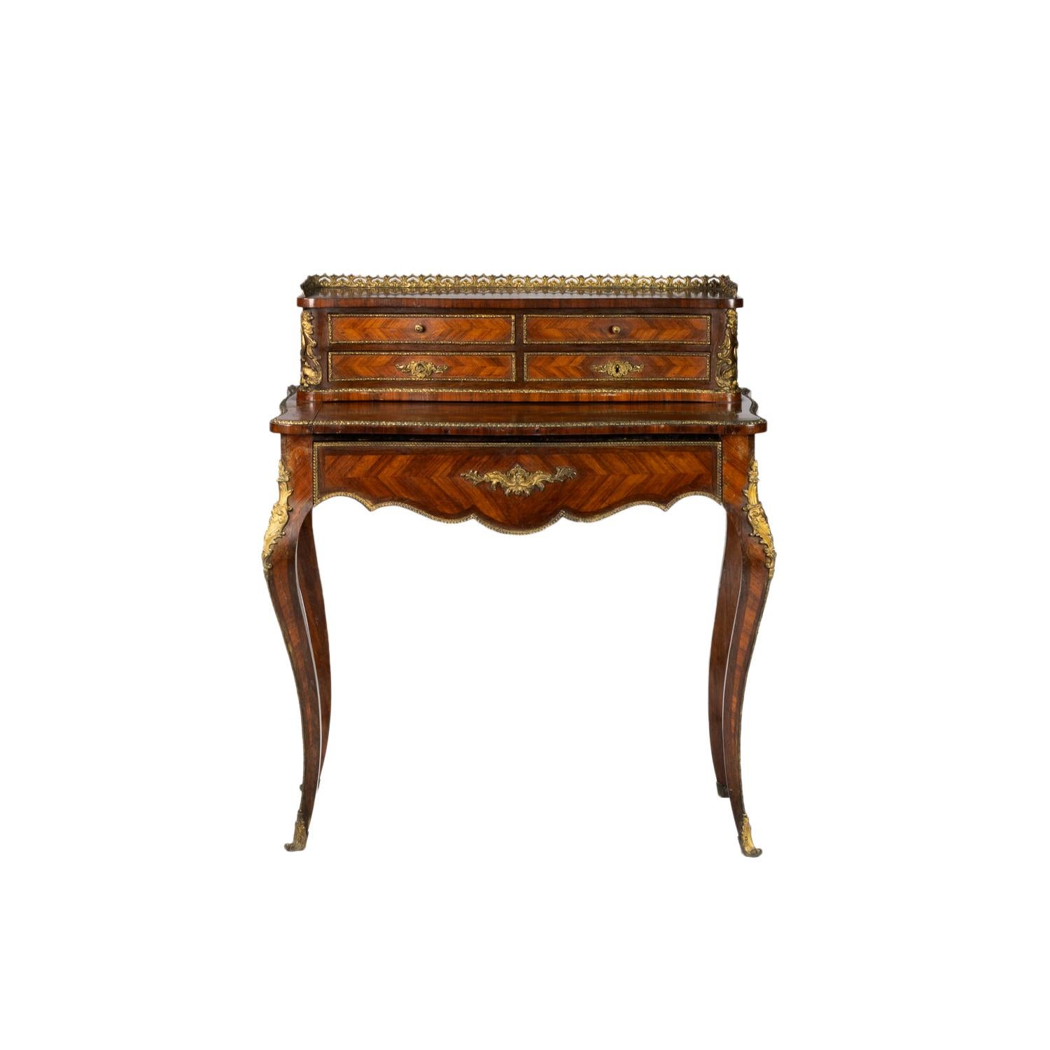 A rare Bonheur Du Jour with gilt brass mounts and exquisite marquetry inlay with French Sèvres Style Porcelain and Ormolu Mounted.
A Louis XVI Style 19th Century piece with four upper draws and one large lower draw with golden rails raised on