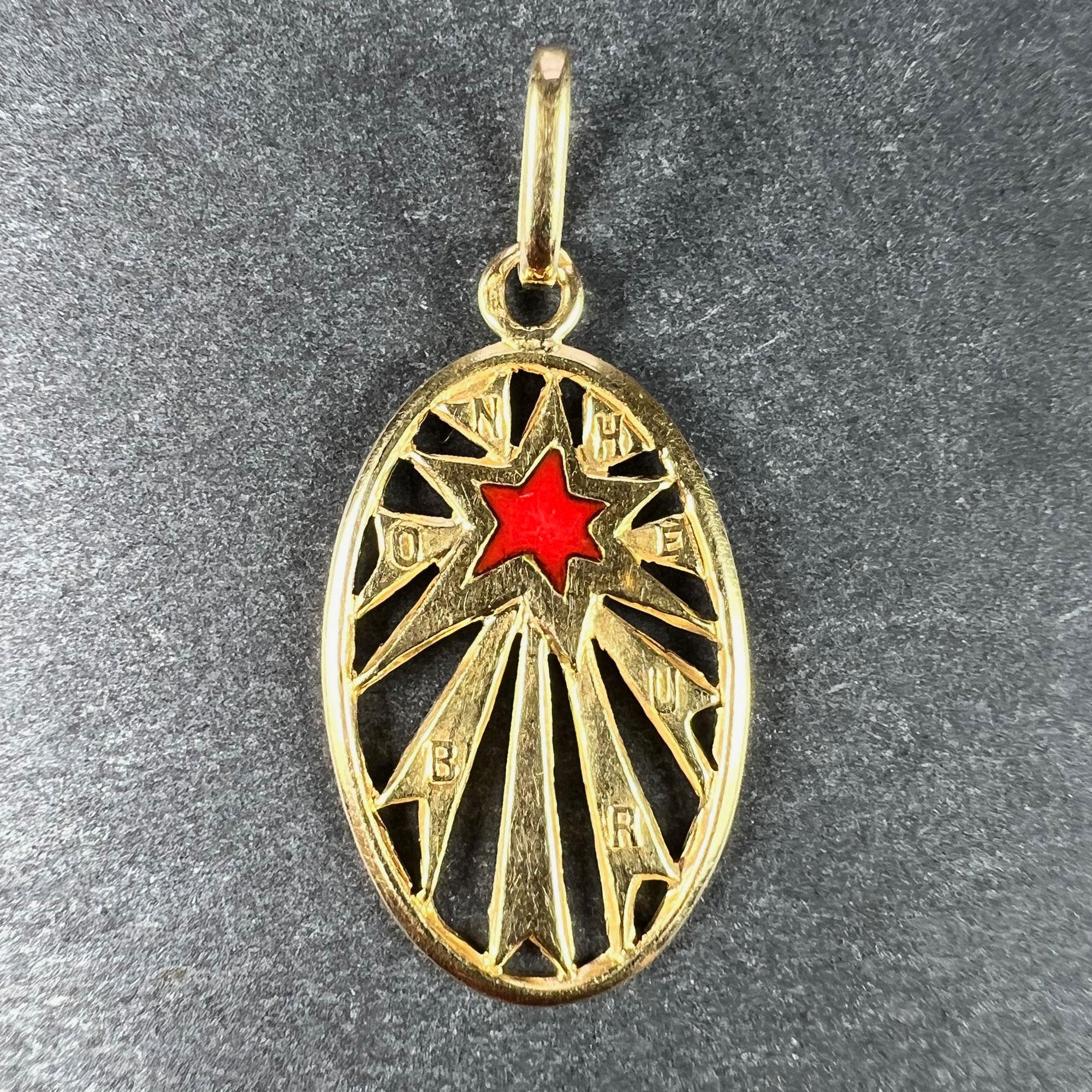 A French 18 karat (18K) yellow gold good luck charm pendant designed as an oval with a red enamel lucky star with radiating lines, with a raised letters spelling the word  'Bonheur' (meaning 'good luck'). 

Stamped with the eagle's head for French