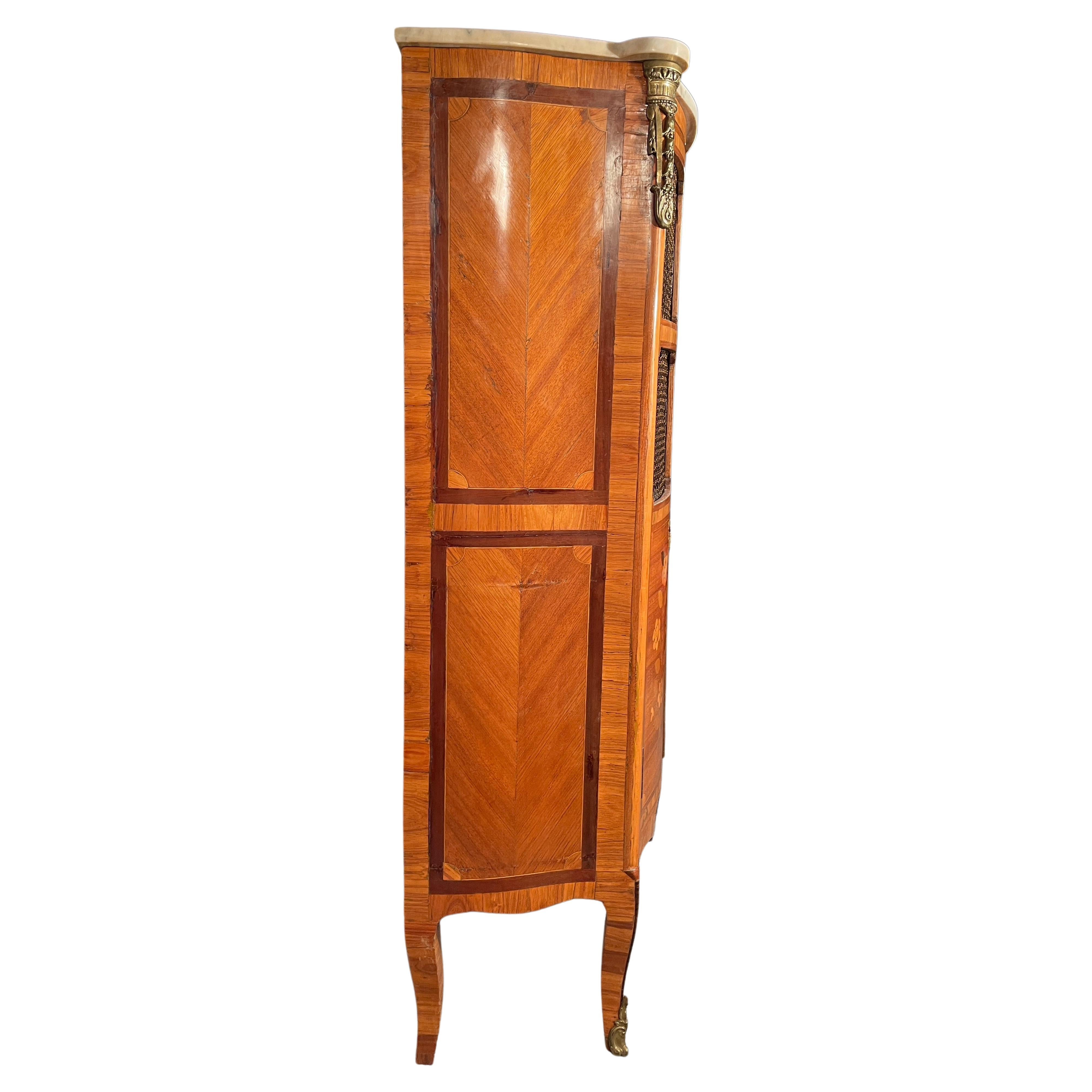 Step back in time with this captivating Napoleon III Bookcase from France, dating back to the 1850-60's. Its charming design features a slightly curved front with two doors, boasting beautifully executed flower marquetry on the lower part and an