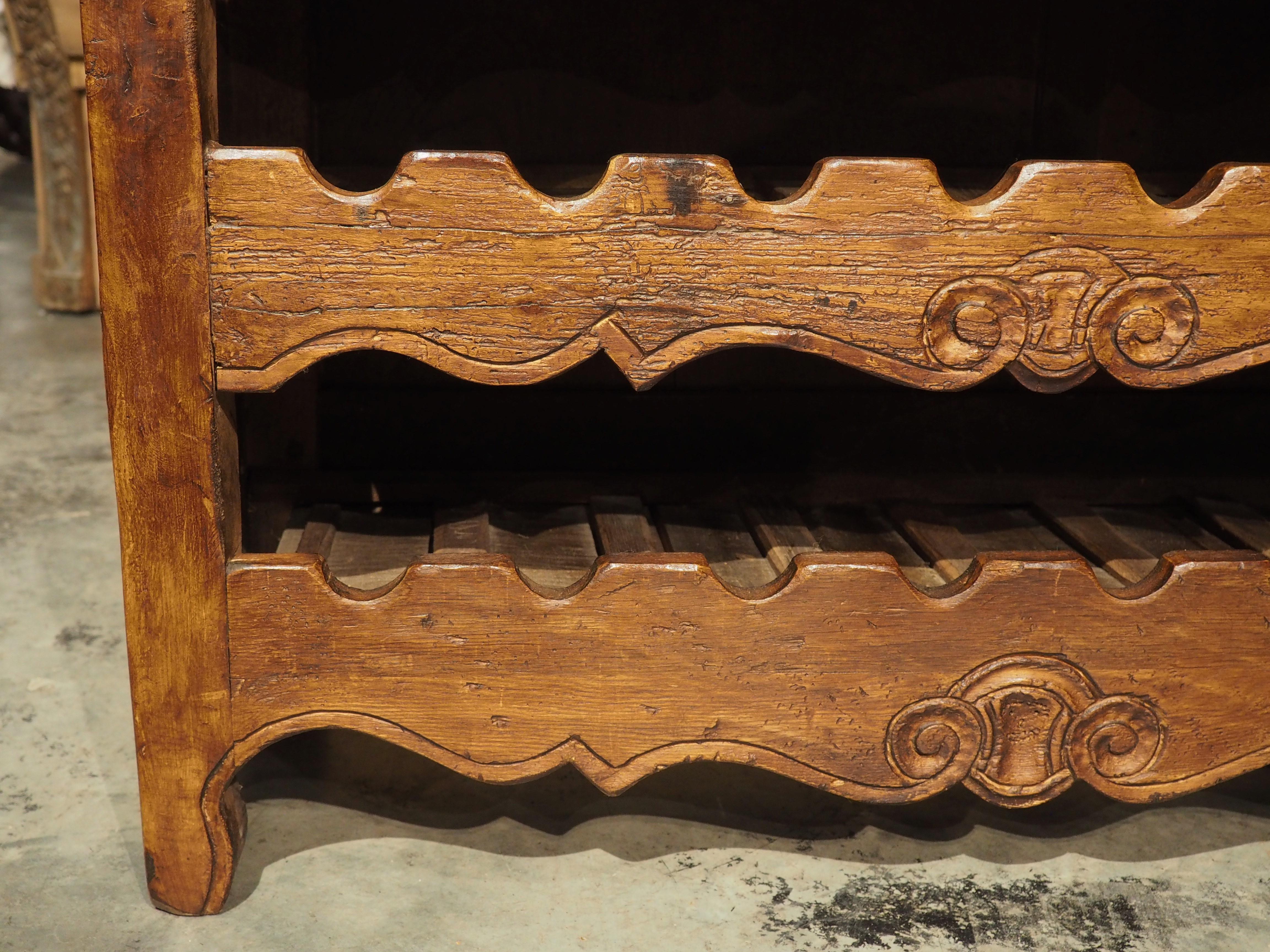 Hand-crafted by a French woodworker who specializes in repurposing antique furniture (in this case 19th century wood), this 24-bottle wine carrier with drawers has Bordeaux painted on the face of the top shelf. This extremely talented woodworker