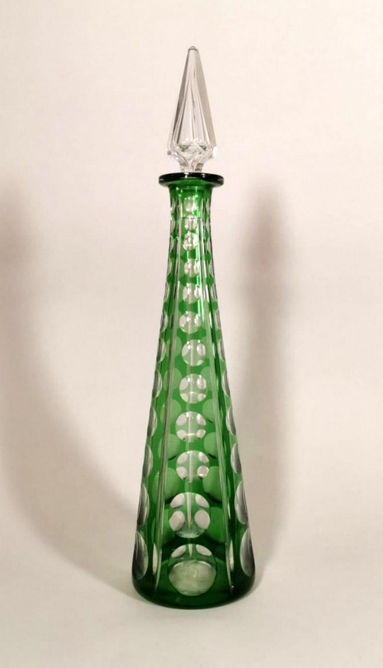  Green crystal bottle, cut and ground by hand, for its execution it was used crystal with a percentage of lead of 30%, the high lead content, instead of calcium present in the common glass, gives the crystal a high refractive index, with the