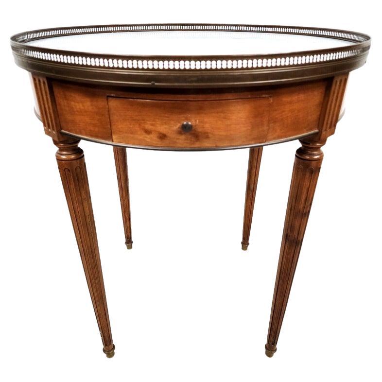 For FULL item description click on CONTINUE READING at the bottom of this page.

Offering One Of Our Recent Palm Beach Estate Fine Furniture Acquisitions Of A
Classic Louis XVI style bouillotte side table in mahogany with a Carrara marble top
