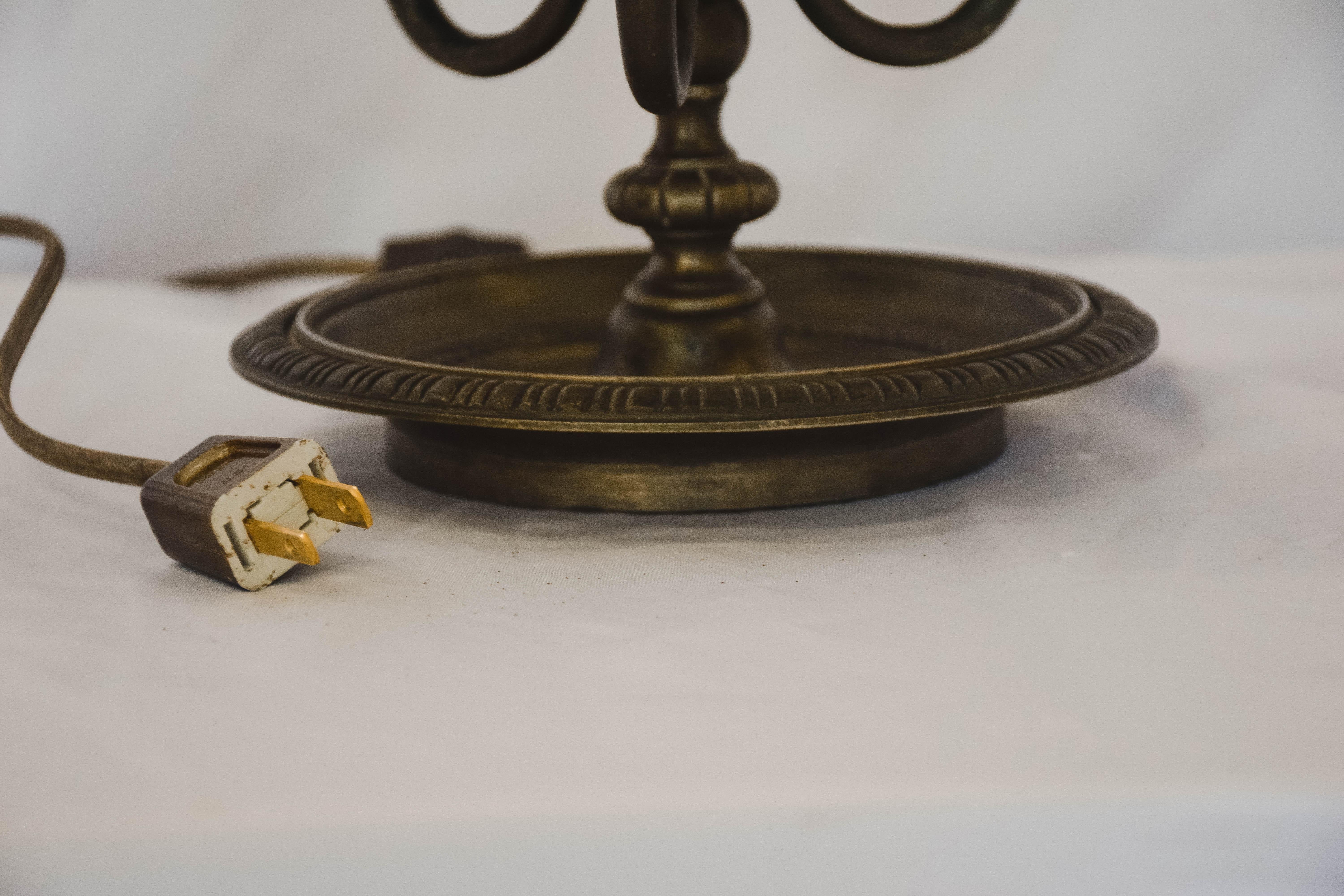 French Bouilotte lamp. Newly wired to US standards. Black shade with gold lining. Gold leaf detail on the exterior of the shade.