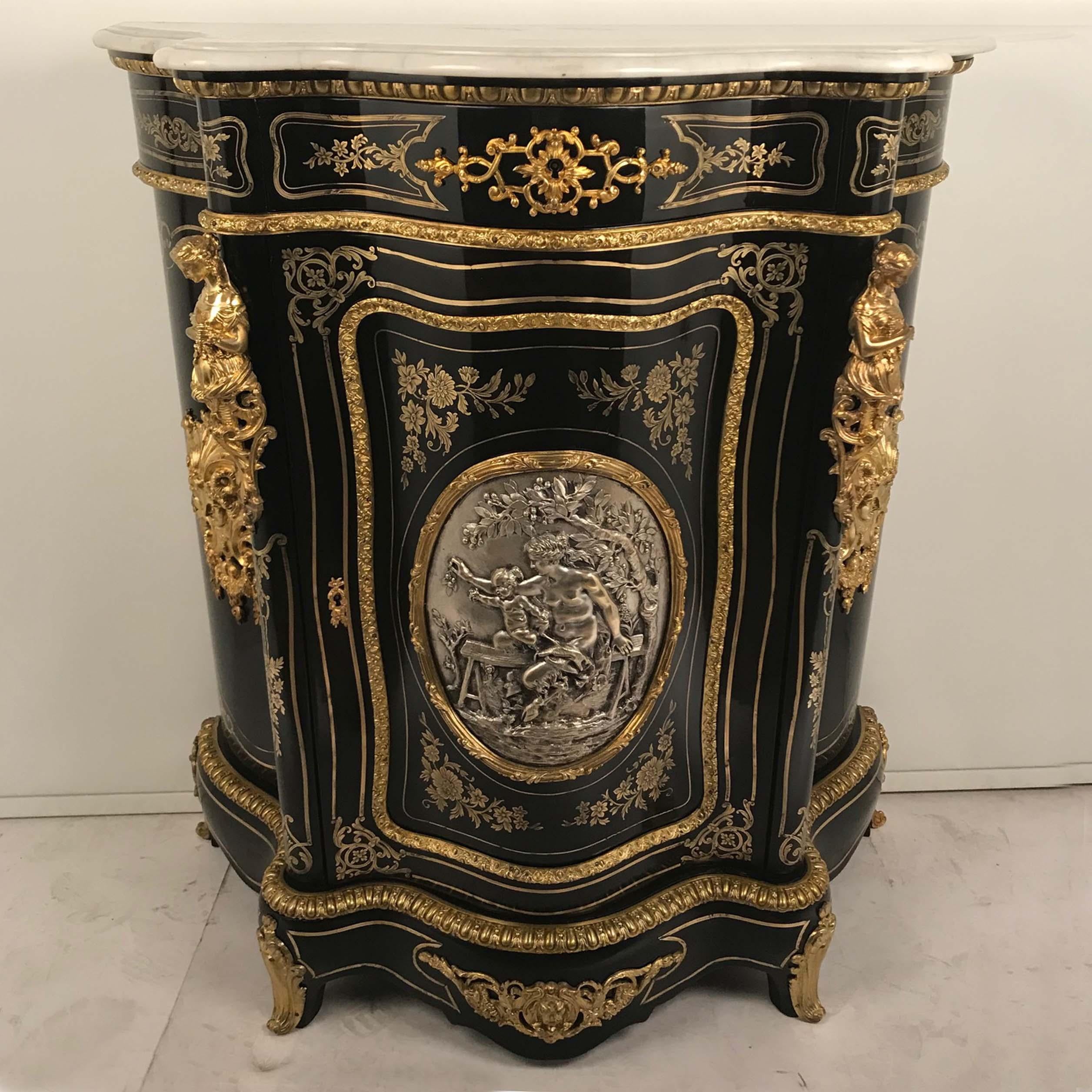 This fine side cabinet is unusually small but crafted to the highest standard. The serpentine outline, cut-brass, ornamental mounts, and choice of timber are all of outstanding quality. It is centred with a large shaped silvered bronze panel of