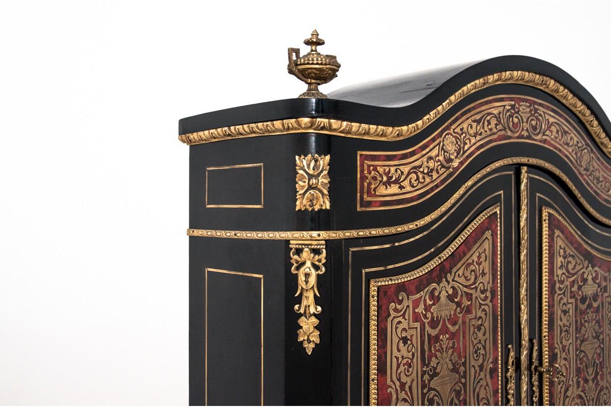 Unique Louis XV style secretary desk cabinet in Boulle style. 
Brass marquetry on a background of red tortoiseshell with gilt bronze ornaments.
Upper part is a cabinet with two drawers from the bottom and two shelves behind the doors.
Under the