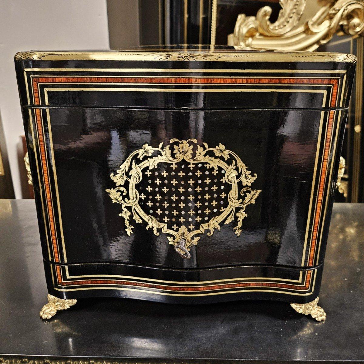 Beautiful liquor cellar in Boulle marquetry with brass fillets on a background of ebony veneer and rosewood fillets, two large cartouches on the hood and the facade, in Queen marquetry composed of brass quartefeuilles embedding small mother-of-pearl