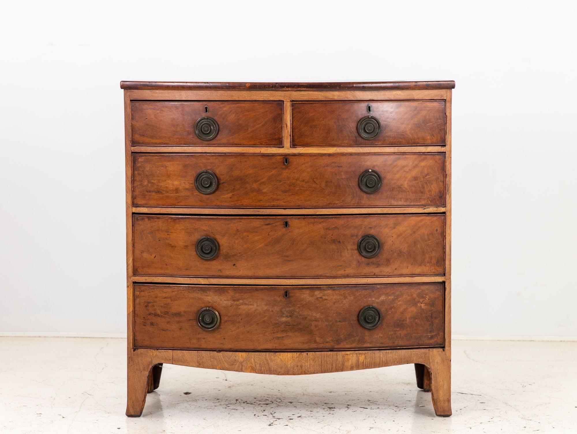 Elegance meets history in this late 19th-century French Bowfront Chest of Drawers. Crafted with meticulous attention to detail, it boasts a gently curving front that lends a graceful and timeless allure. The warm patina of aged wood showcases the