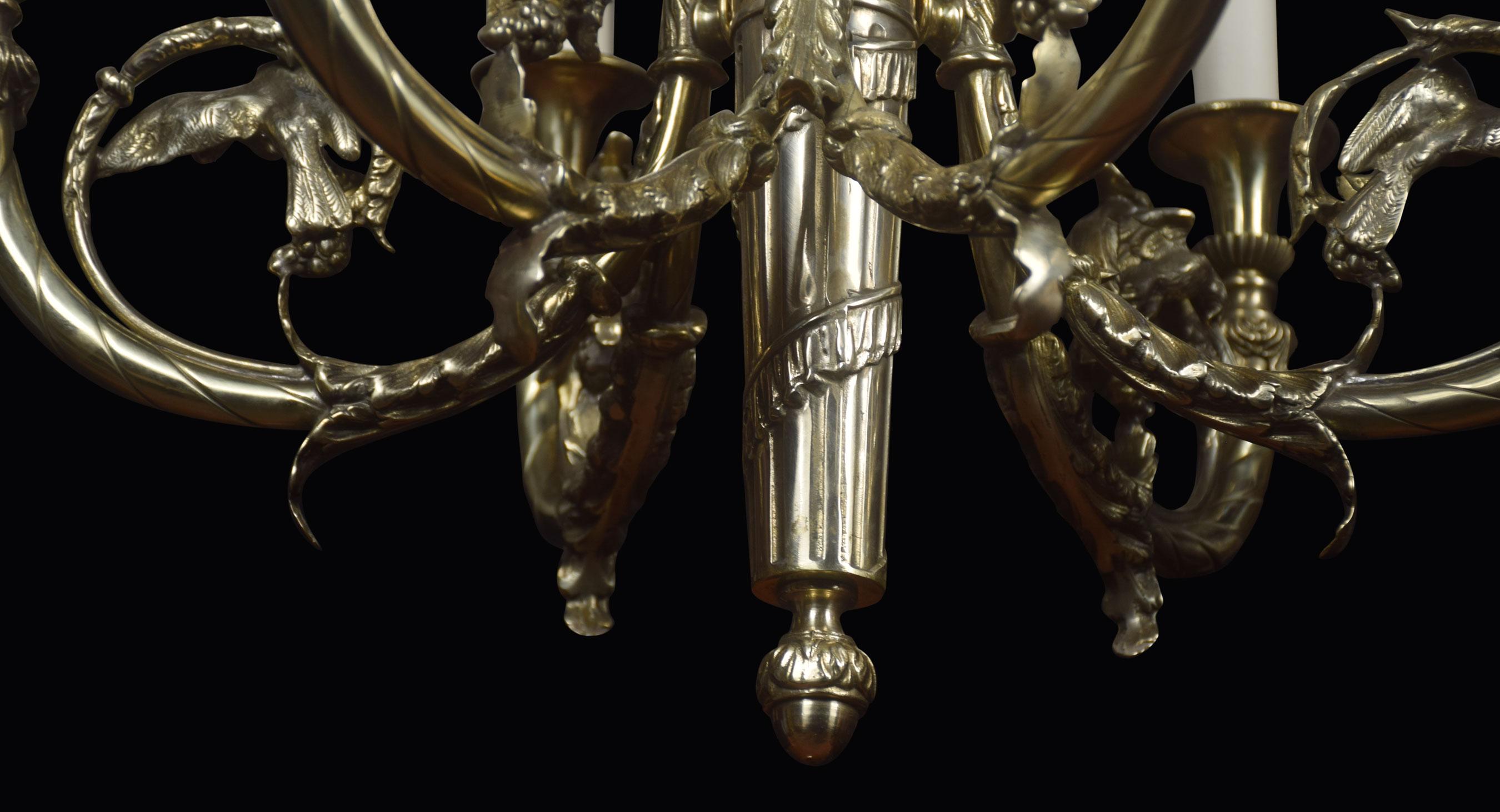 French brass six branch chandelier, the three rope twist effect supports extending to cast goats masks, followed by two branches, each surmounted with an eagle within a foliate ring, united by a central tapering column. The chandelier has been