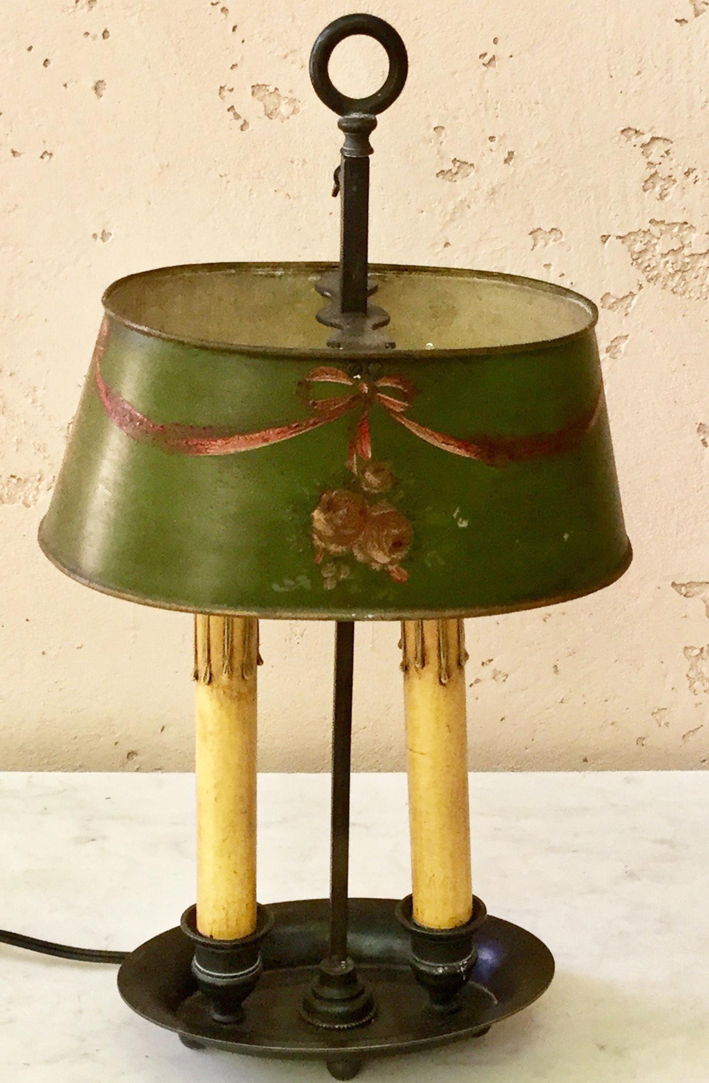 A charming double 19th century, French Bouillote lamp with an ovale green tole shade painted with bow and flowers.
Wired for US.