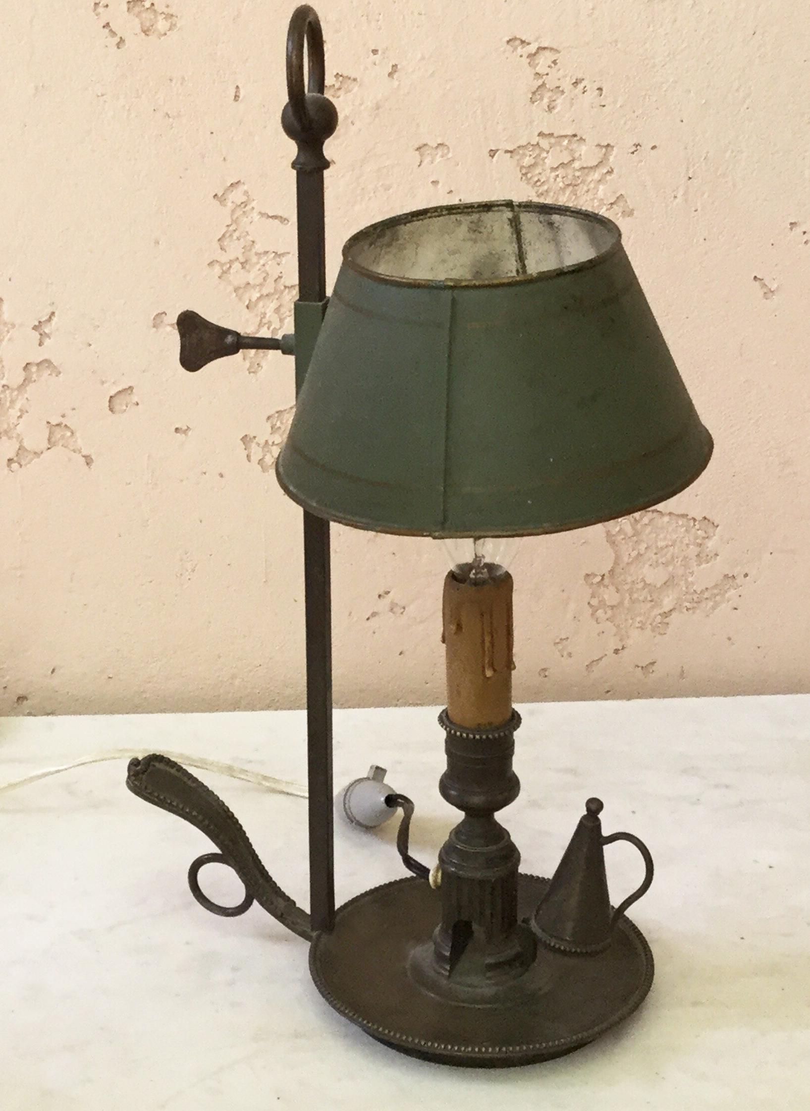 Elegant 19th century French brass bouillote lamp with a green tole shade.
The lamp have an handle and the piece to switch off the candle, originally used for a candle , electrified latety.
Wired for US.