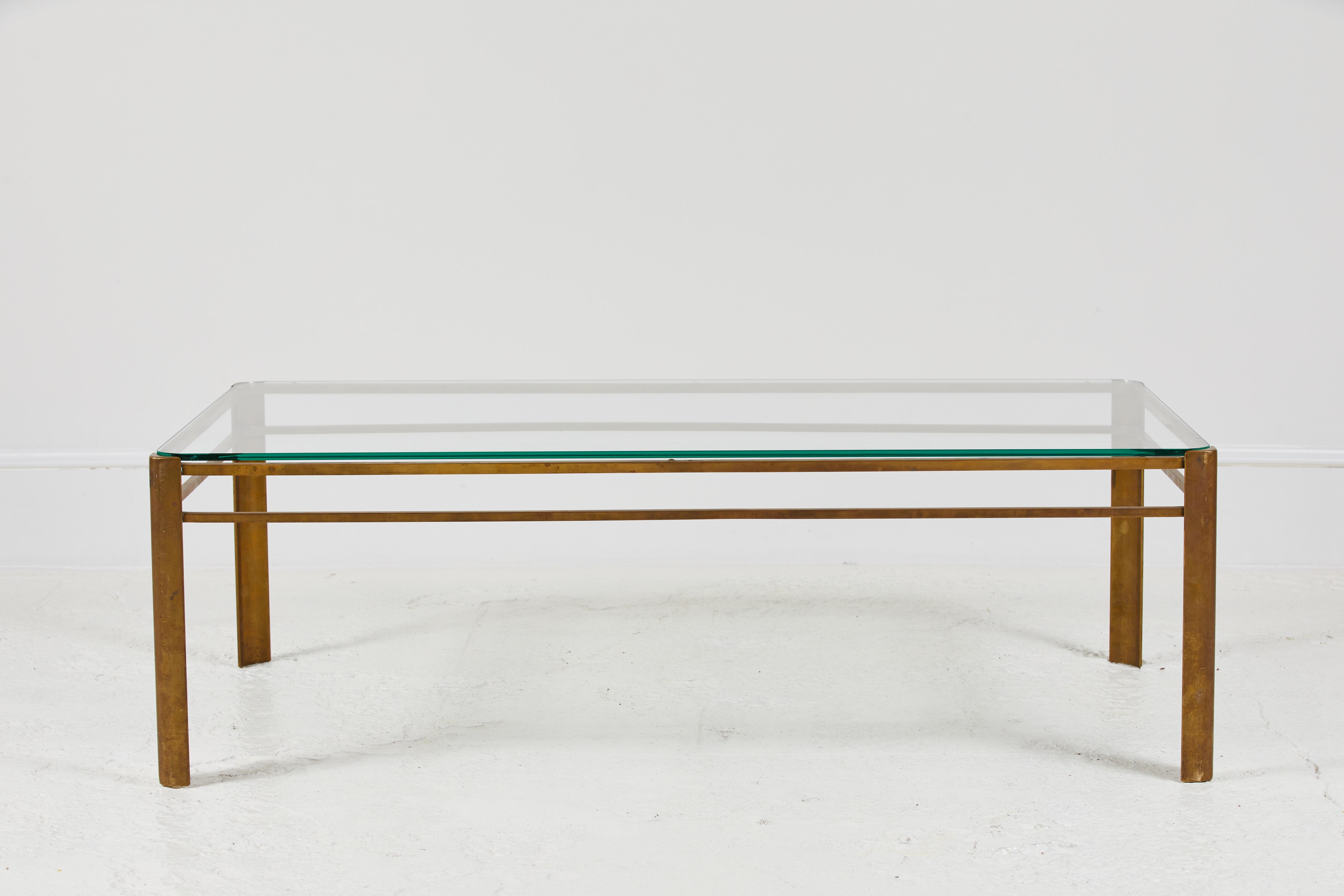 Beautiful deco inspired petite French brass and glass coffee table by Jacques Quinet.