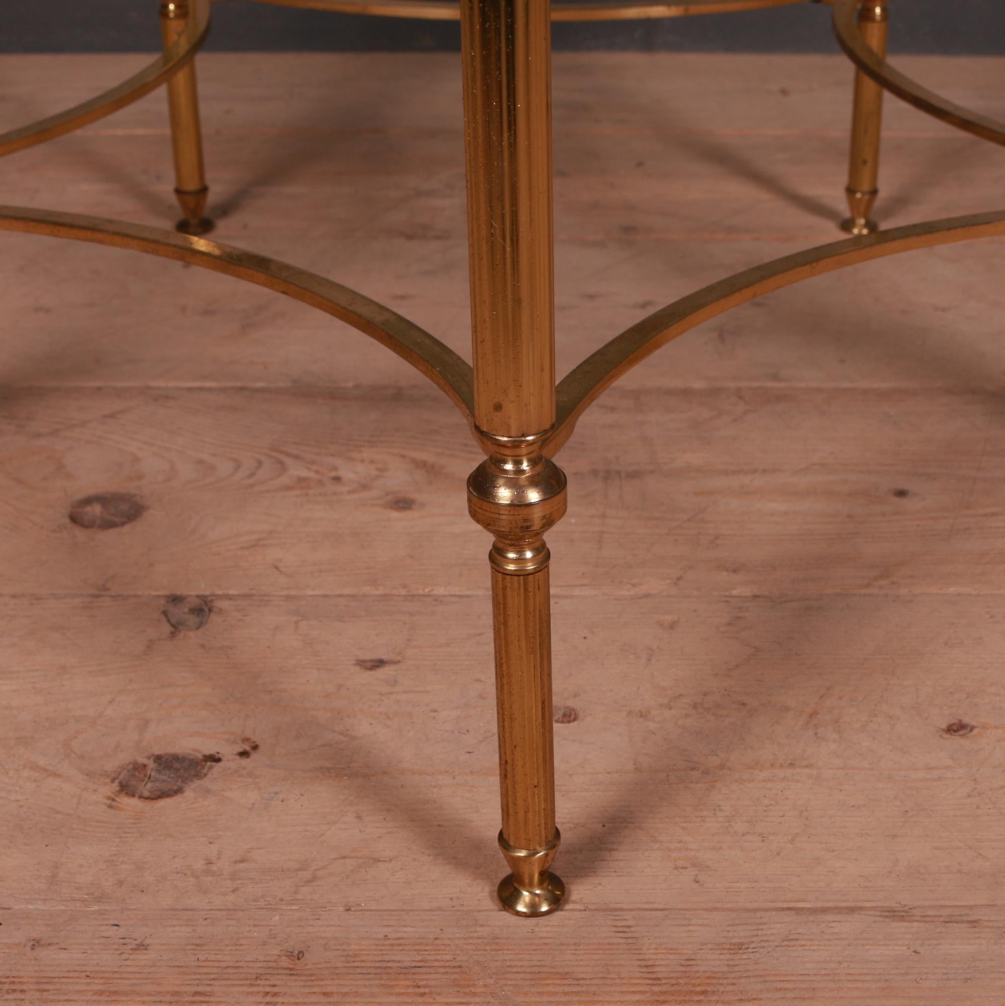 1950s French brass and glass side table with clear glass.

Dimensions:
16 inches (41 cms) high
30 inches (76 cms) diameter.
 
   