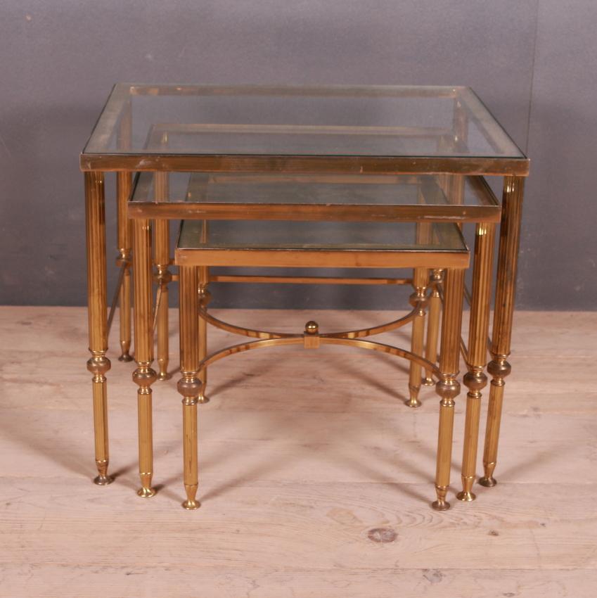 Set of 1950s French brass and glass tables. Clear glass.

Dimensions of smallest table: 14.5