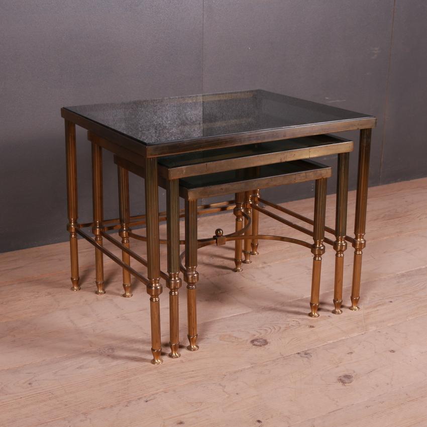Set of 1950s French brass and glass tables. Smoked glass.

Dimensions of smallest table = 14
