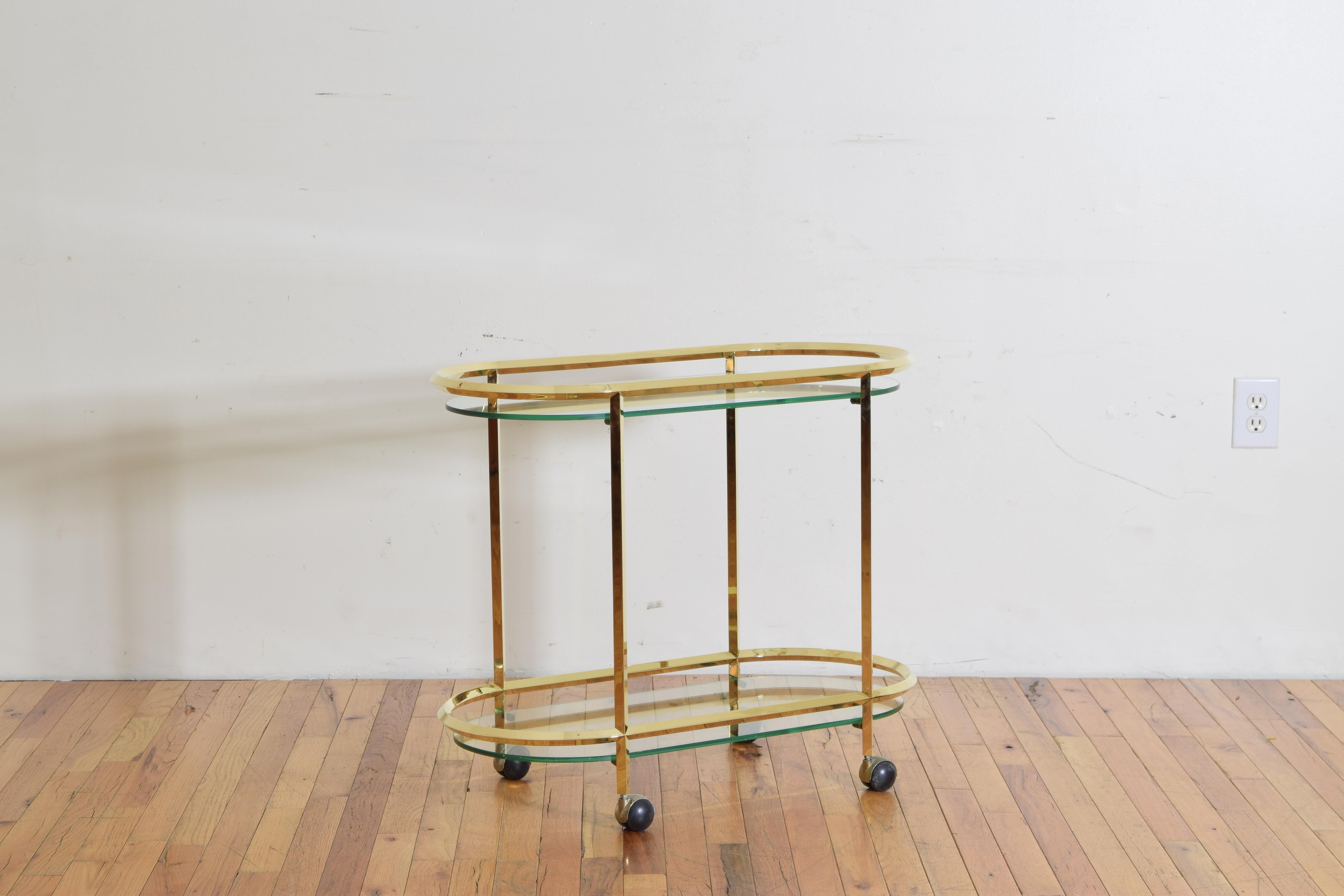 The bar cart is of disco rectangular shape and having two horizontal tiers joined by four vertical supports, each level having a thick conforming piece of glass slightly below, raised on original brass and plastic feet.