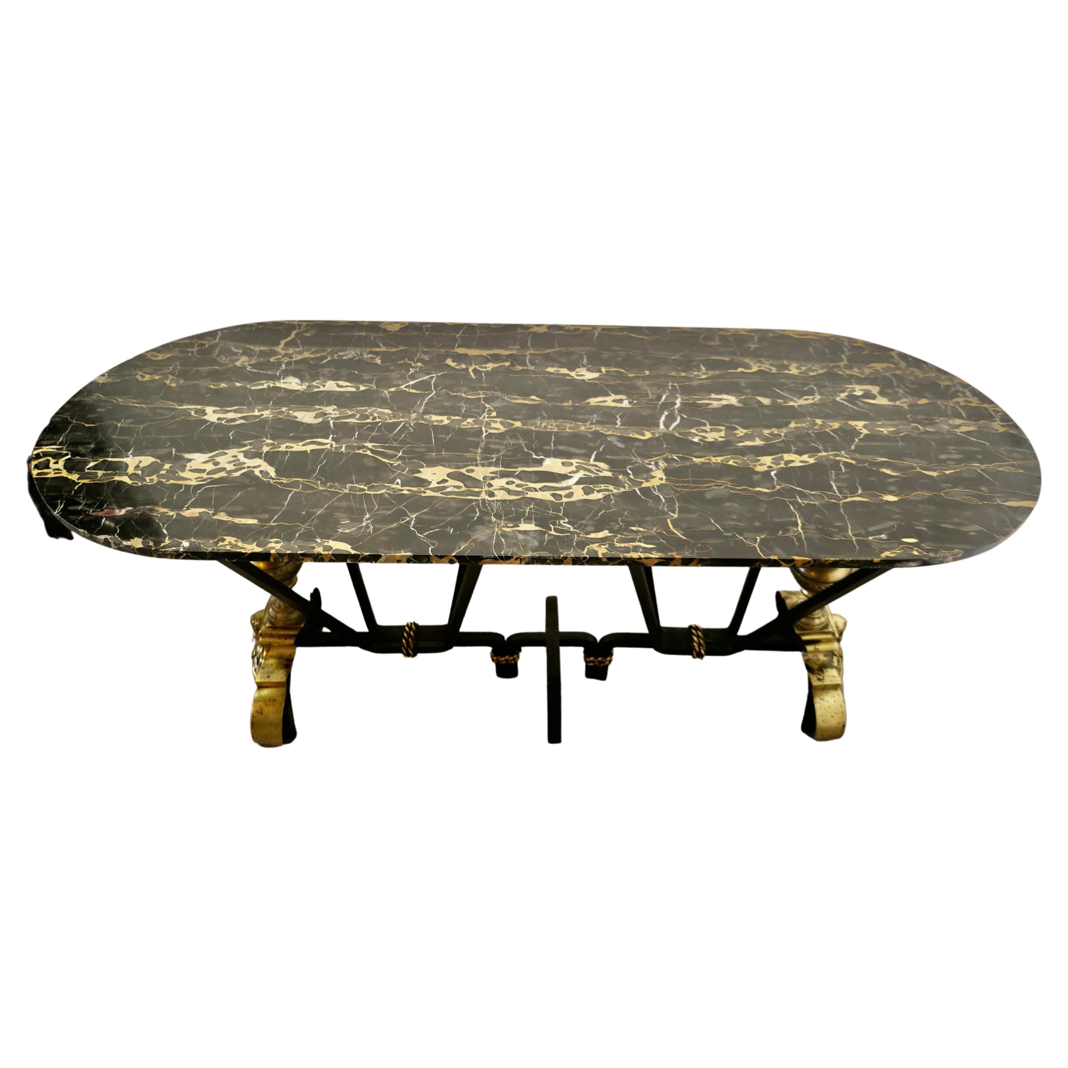 French brass and iron marble top centre table 

This is a very attractive bespoke table, the base of this long centre table is made in Iron and has detailed decoration in brass, the table base is necessarily very strong, with 4 sets of legs and a