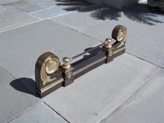 French Brass and Polished Steel Chenet with Scrolled Foliage Medallion. C. 1815