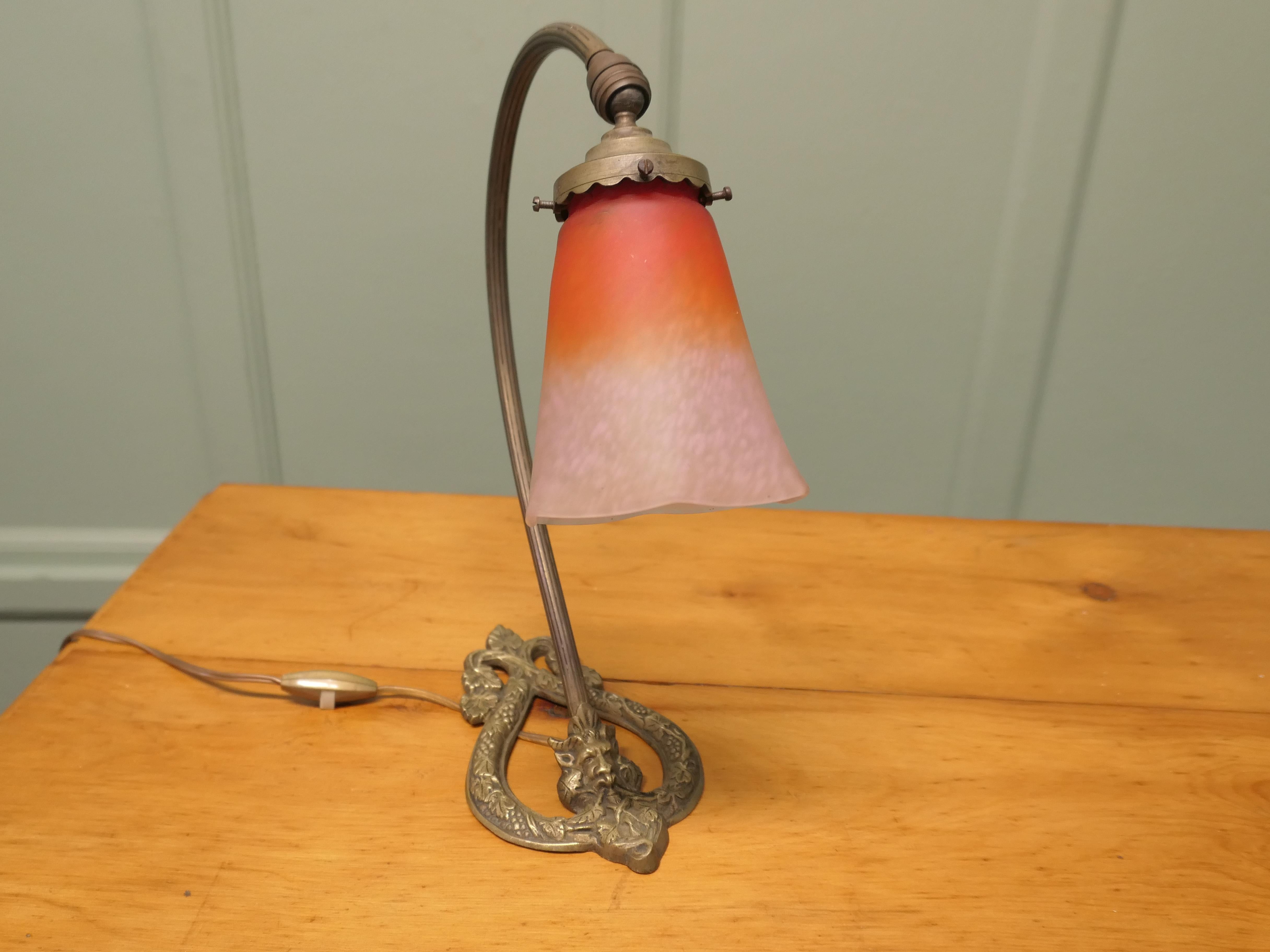 French Brass Bacchus Table Lamp with Opaline Glass Shade

This is a very attractive piece, the lamp has a central column which is set on an unusual brass base with Celtic motifs and the face of the green man or perhaps it is Bacchus
The lamp comes