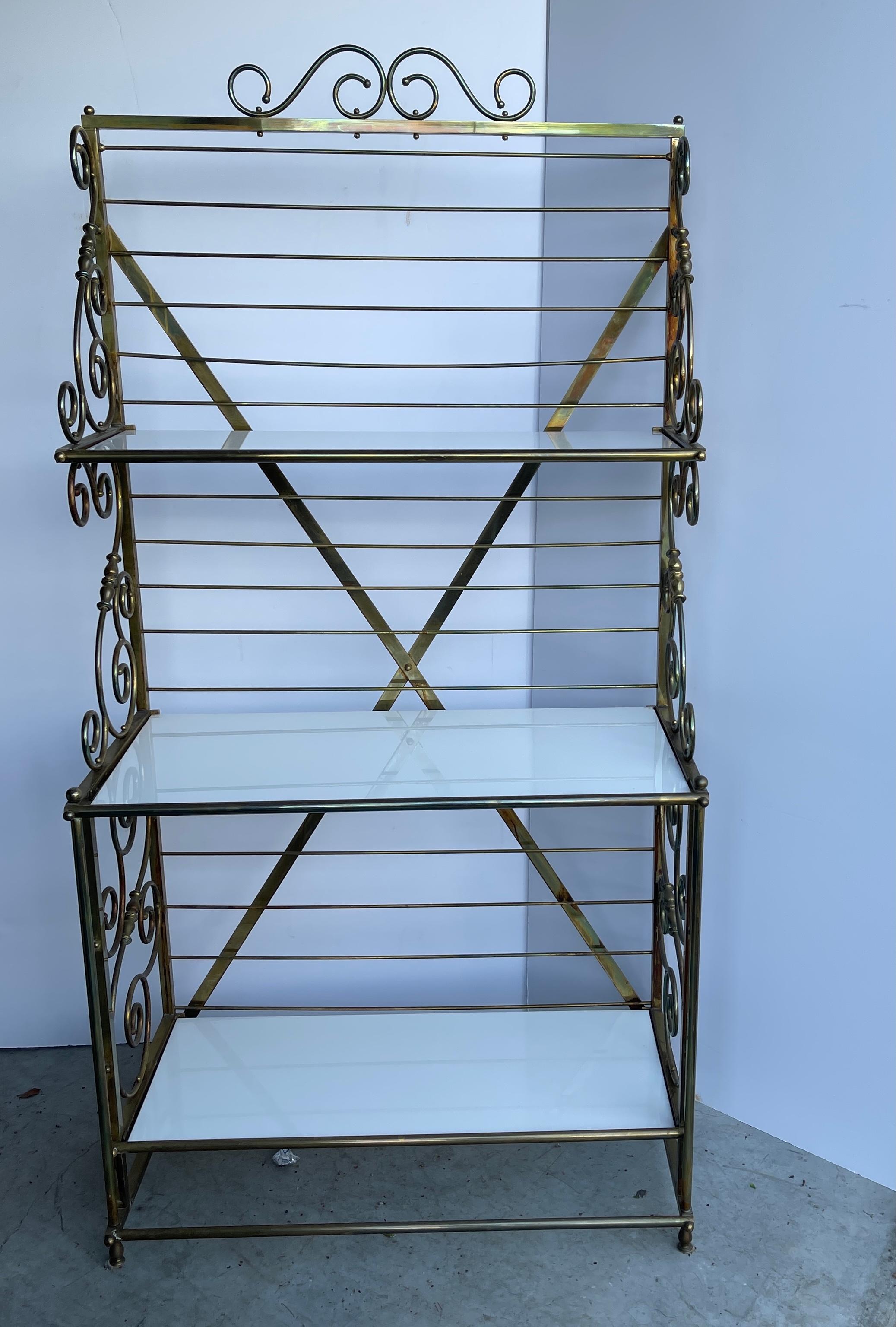 Vintage three-tier bakers rack in brass and thick white milk glass shelves.
This is a spectacularly stylish French brass baker’s rack with amazing patina.