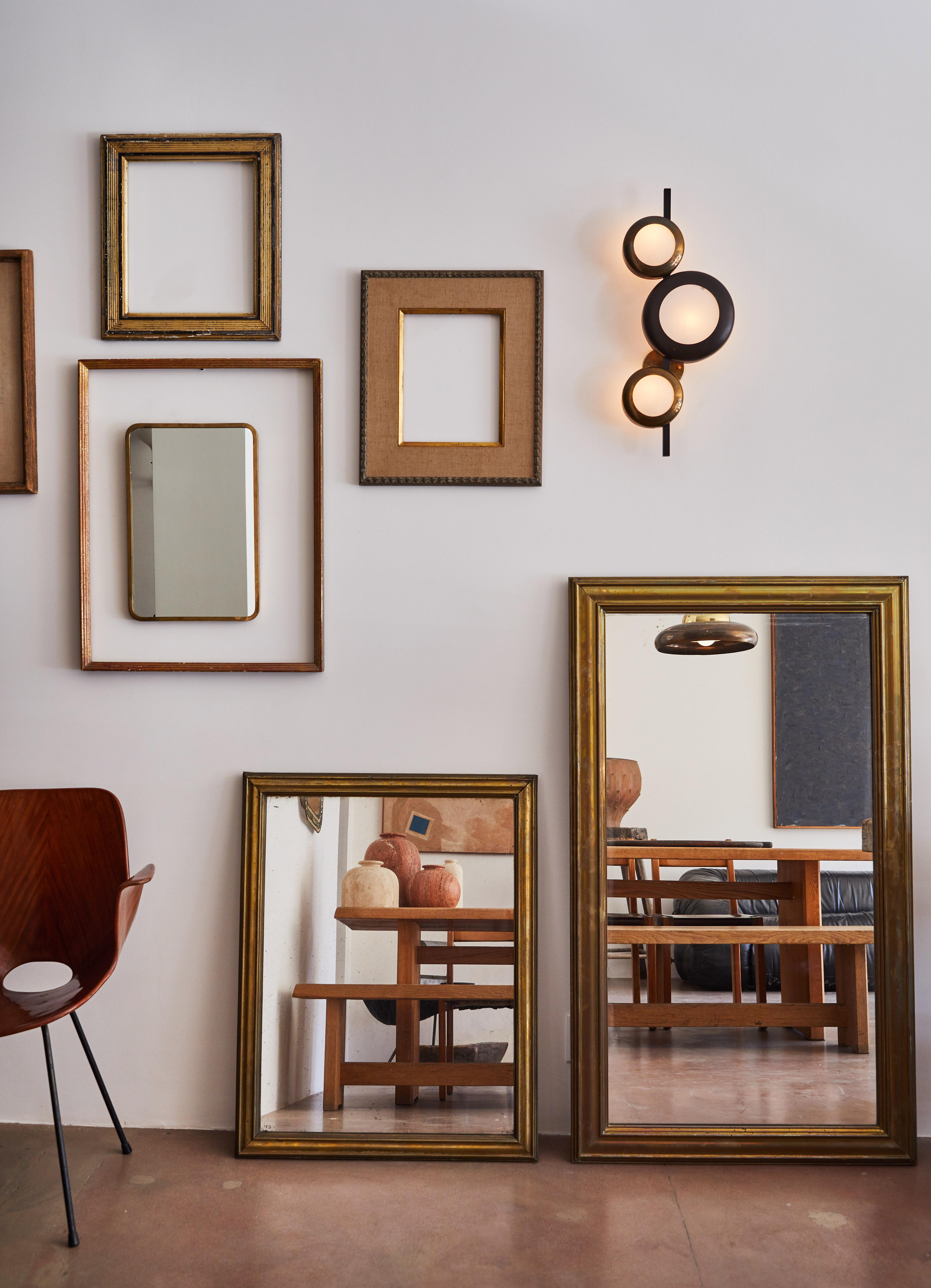 Patinated brass bistro mirror with mercury glass. Made in France, circa 1910.