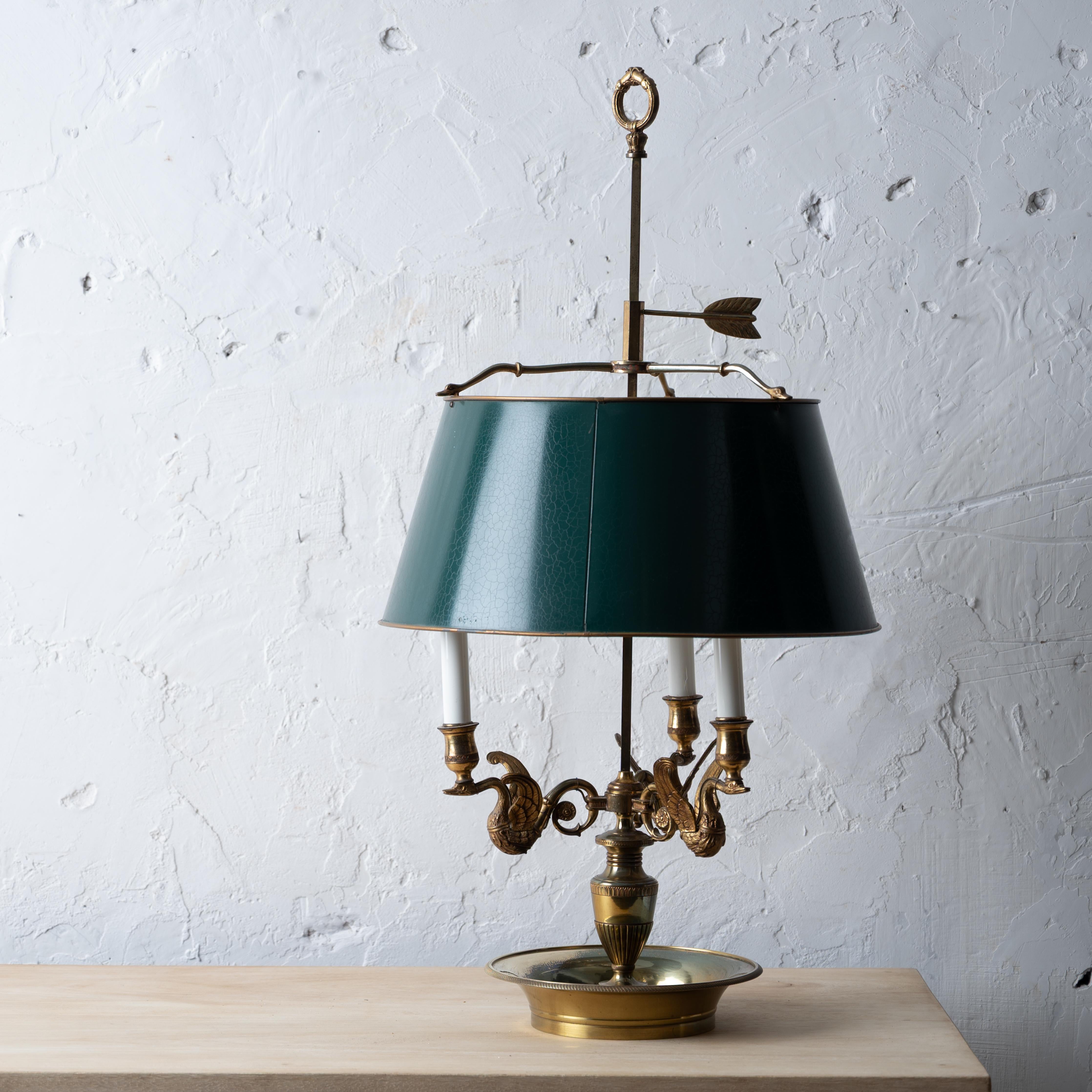 A French brass bouillotte lamp with swans and tole shade, 20th century.



16 ½ inches wide by 31 inches tall




