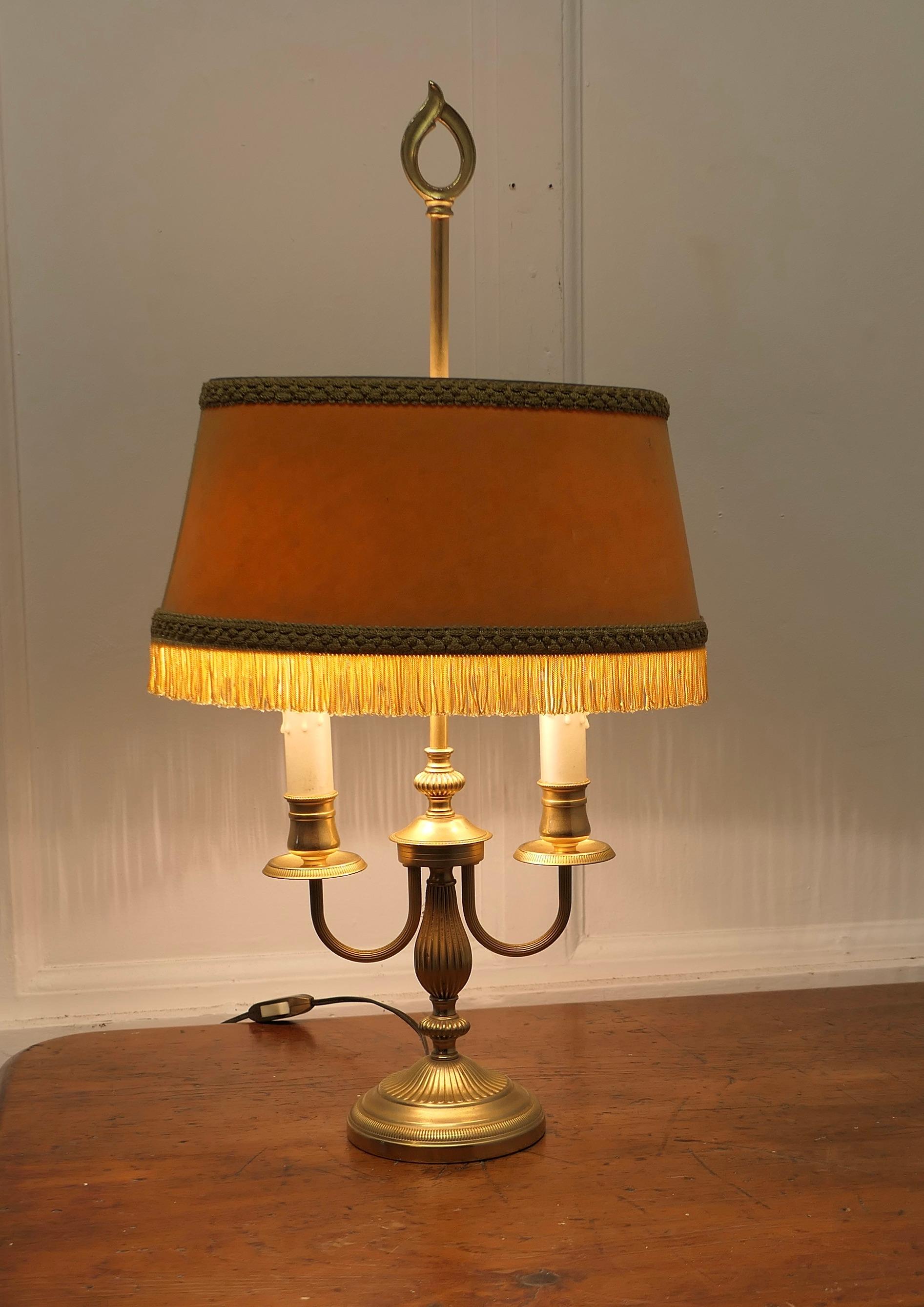 French Brass Bouillotte Twin Desk Lamp

A lovely piece, a brass twin sconce lamp with its original velvet fringed shade 
A  Very traditional design with two candles, the shade is original Gold Velvet
The lamp is all working and in good condition 