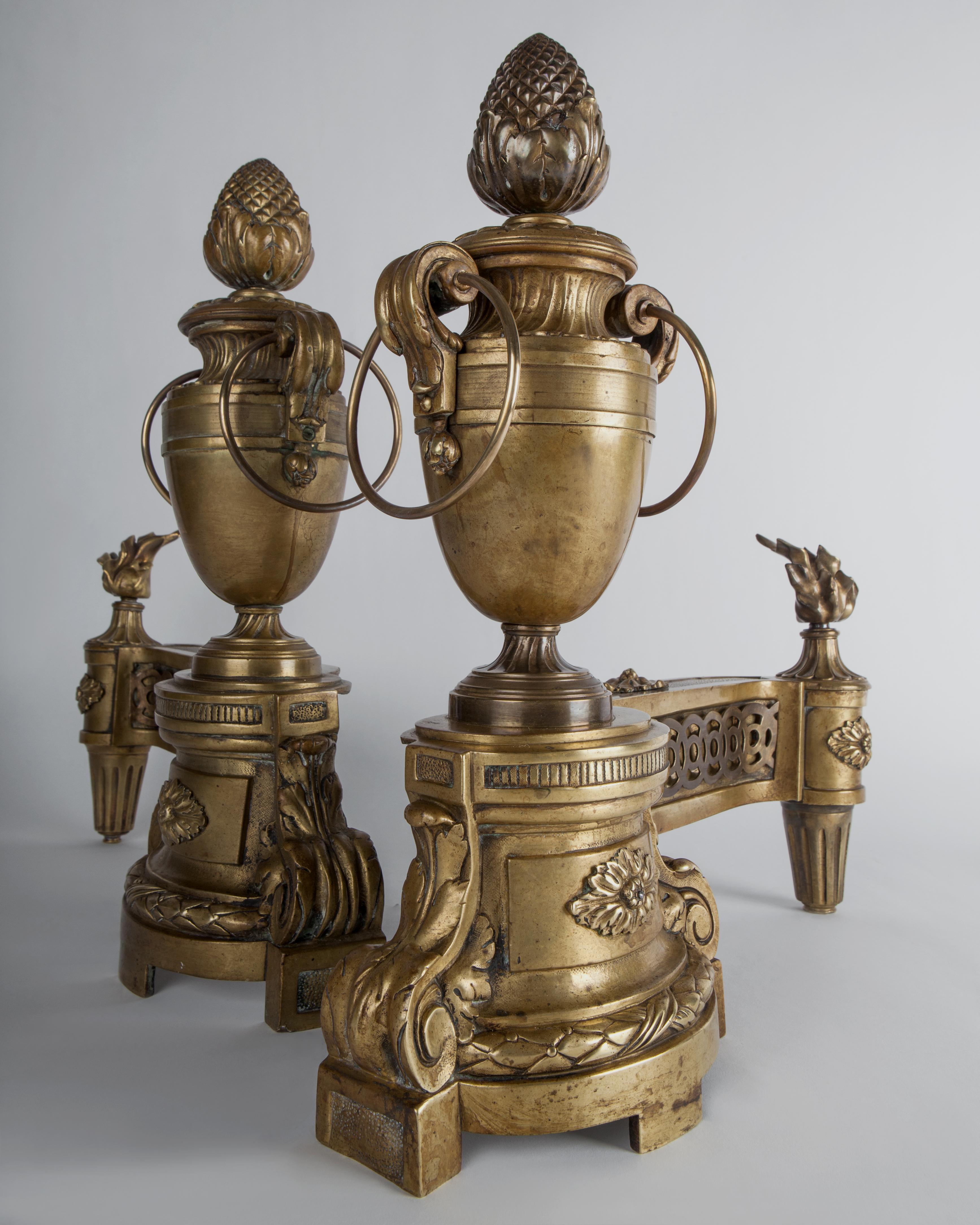 Neoclassical French Urn Form Chenets with Flame and Pinecone Finials in Aged Brass, c. 1860s For Sale