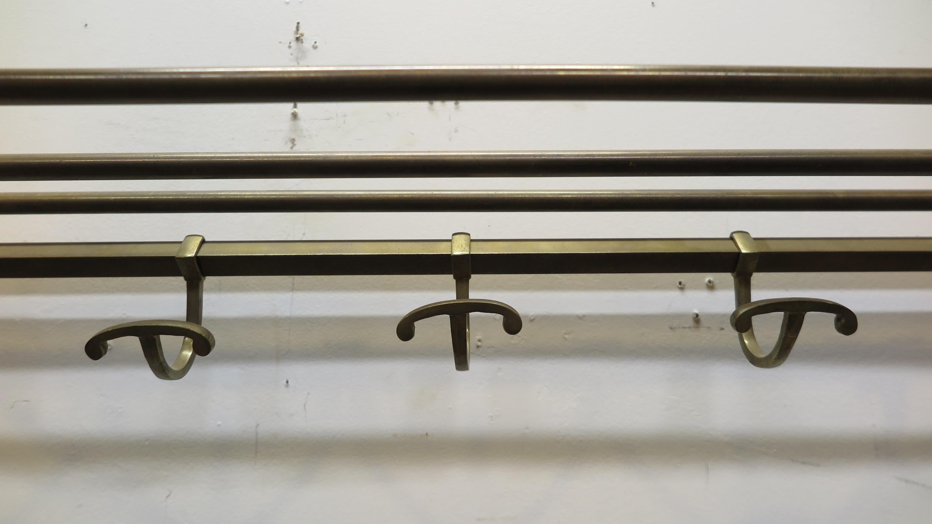 Antique French brass bistro coat rack. Hangers slide for positioning, shelf of brass rods on top.
In good condition brass has patina. Easily mounts to a wall, perfect for everyday use, France, 1910-1920.